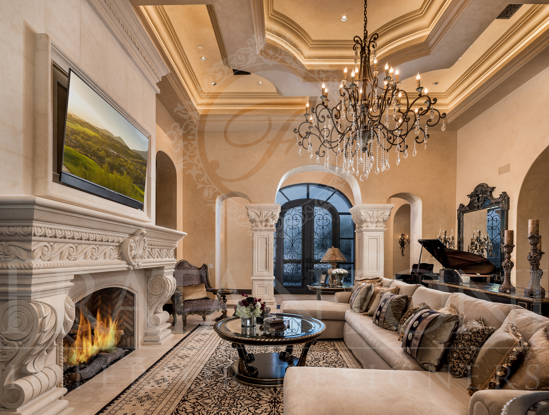 Luxurious living room with fireplace, ornate ceiling, chandelier, and a large sofa.
