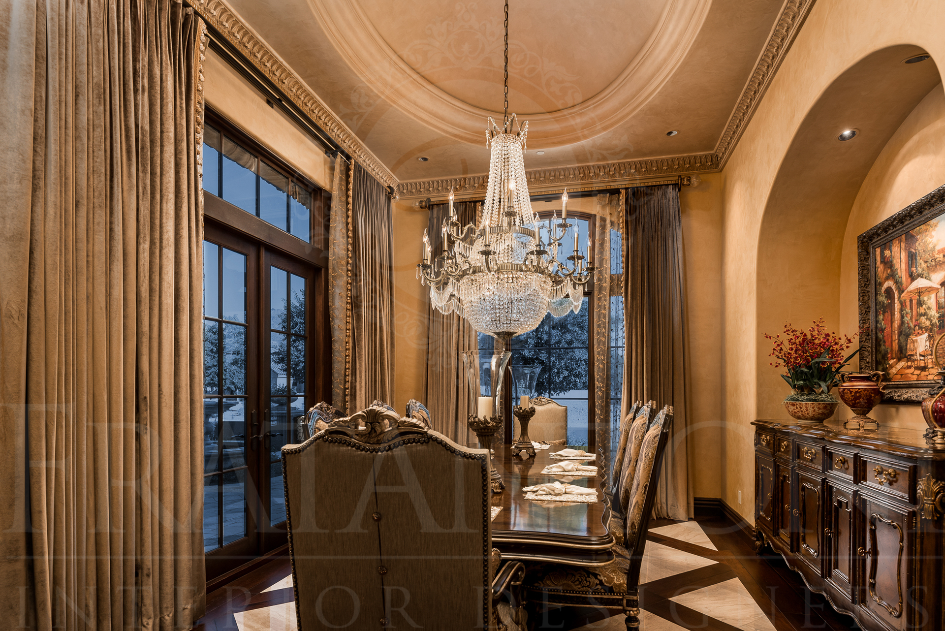 Elegant dining room with chandelier, long table, ornate sideboard, and window with gold curtains.