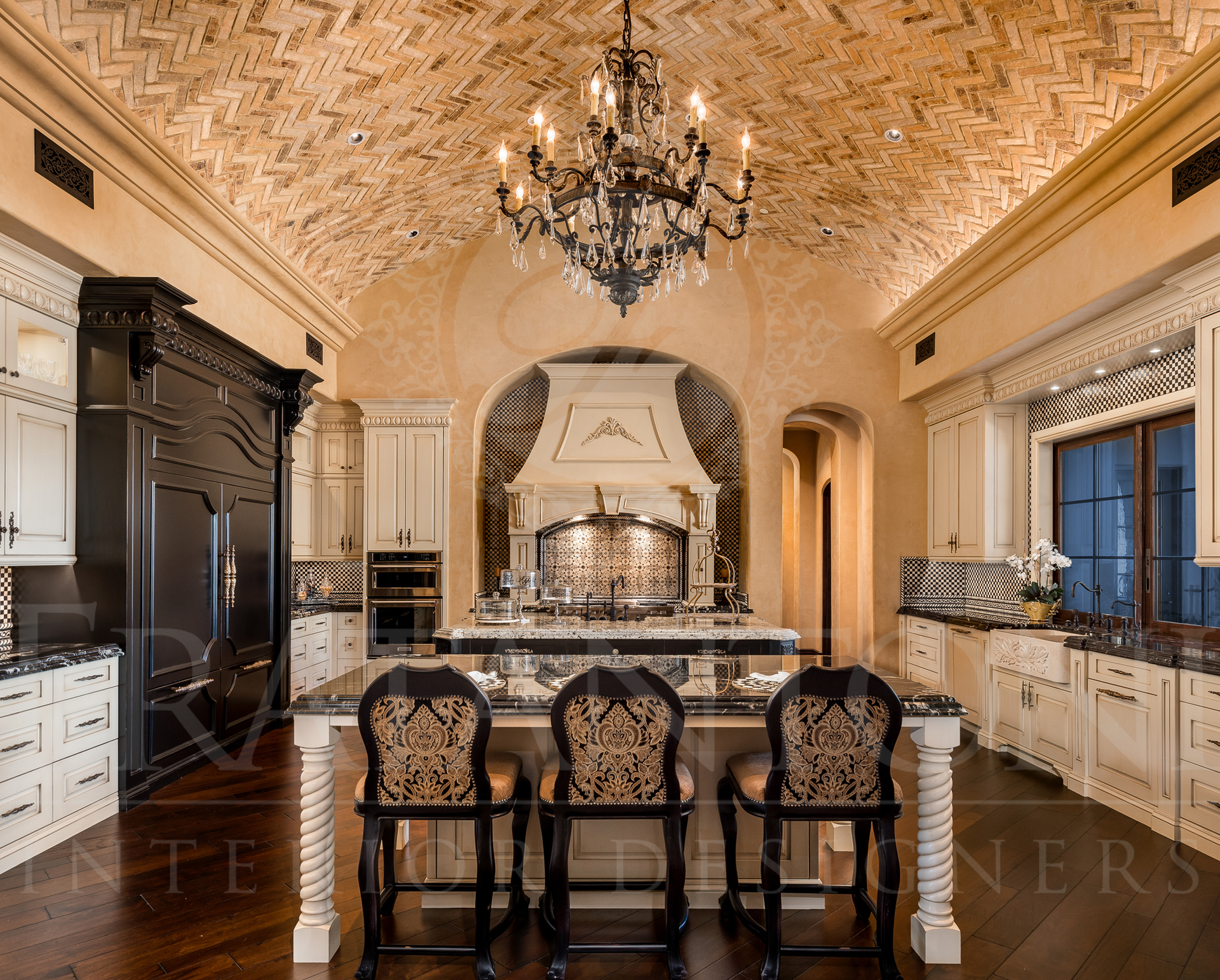 Luxurious kitchen with intricate ceiling design, island, and ornate chandelier.