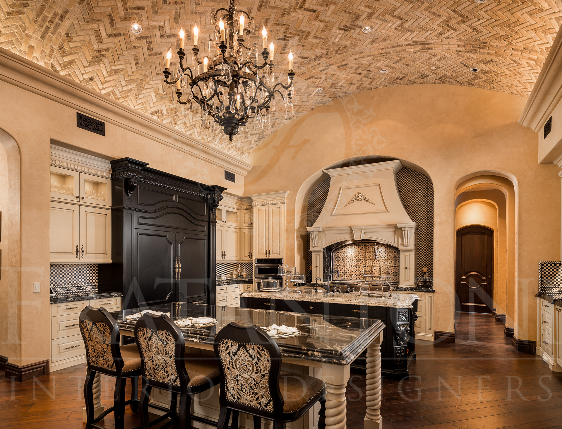 Luxurious kitchen with black and white checkered accents, ornate ceiling, chandelier, and a large island with seating.