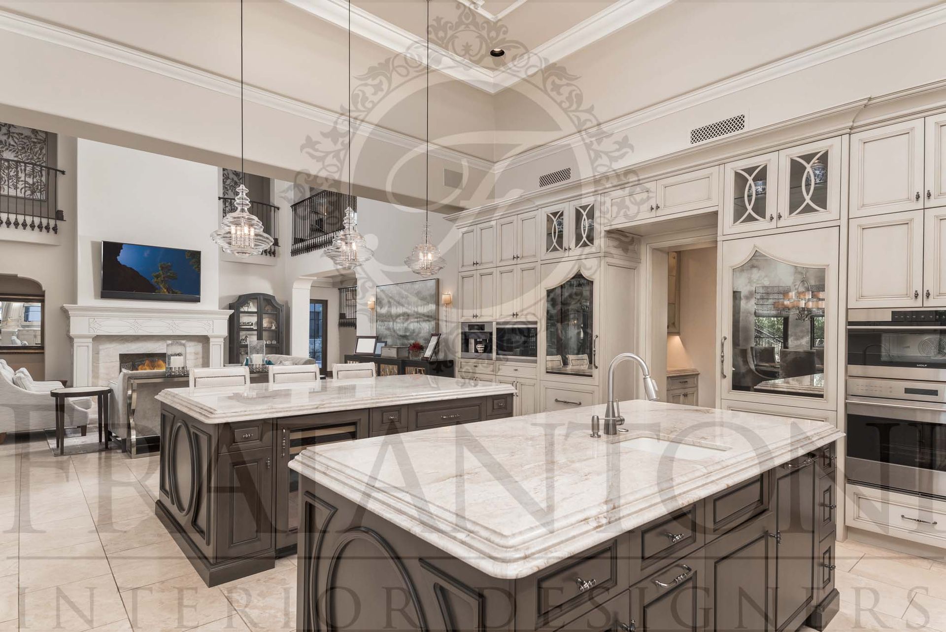 Elegant transitional kitchen with white marble double islands, dark wood cabinetry, custom mirrored panel refrigerators, and glass pendant lighting