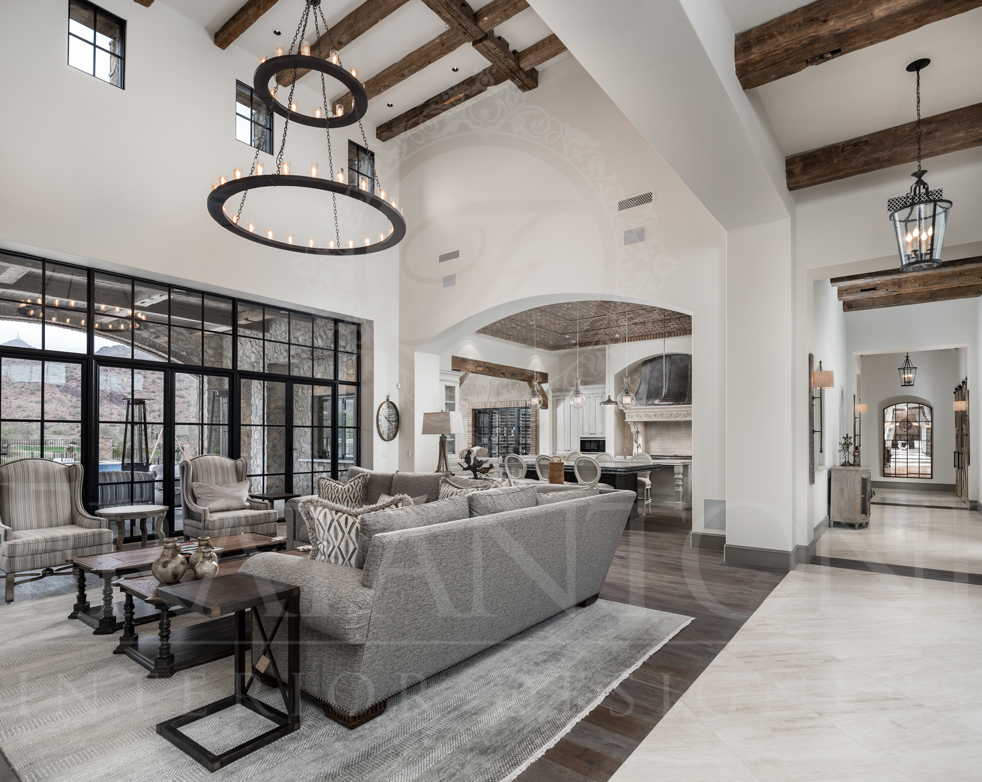 Spacious, elegant living room with neutral colors, large windows, and decorative lighting.