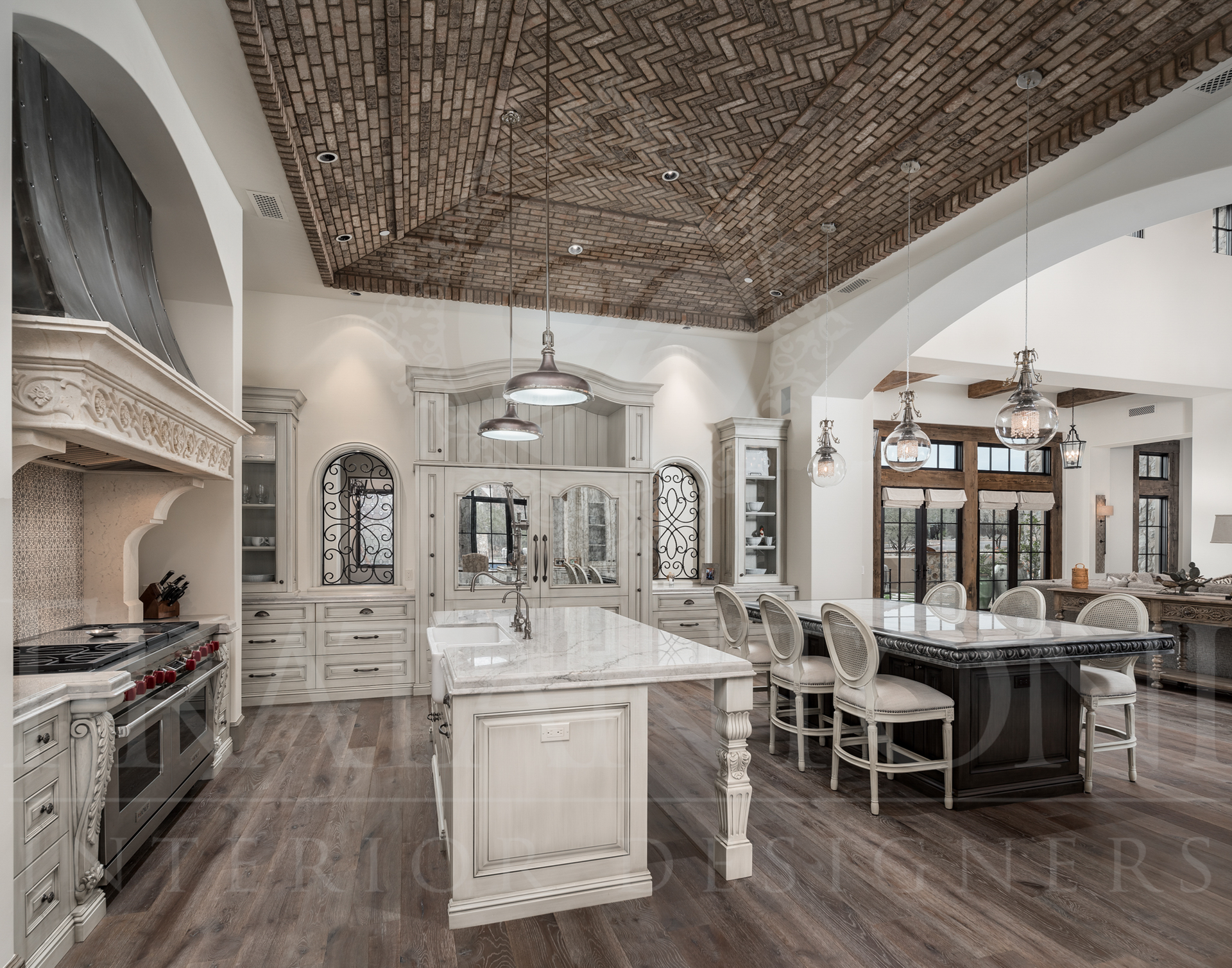 Spacious kitchen with brick-detailed ceiling, double islands, and dining area, featuring neutral tones and elegant design designed by Fratantoni Interior Designers in arizona.