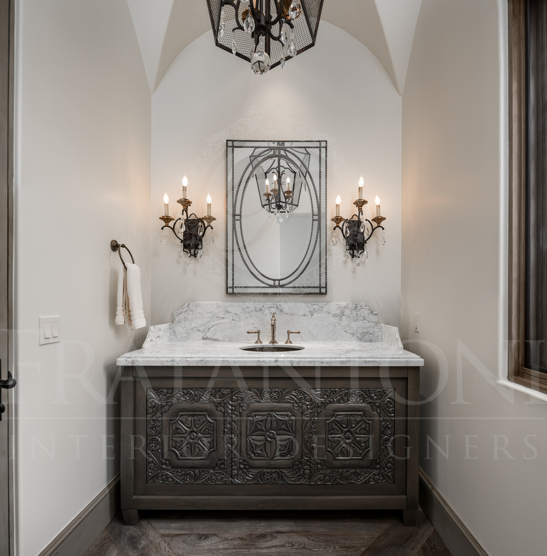 Powder room with ornate gray vanity, marble countertop, decorative mirror, sconces, vaulted ceilings, and chandelier designed by Fratantoni Interior Designers in Scottsdale arizona. 