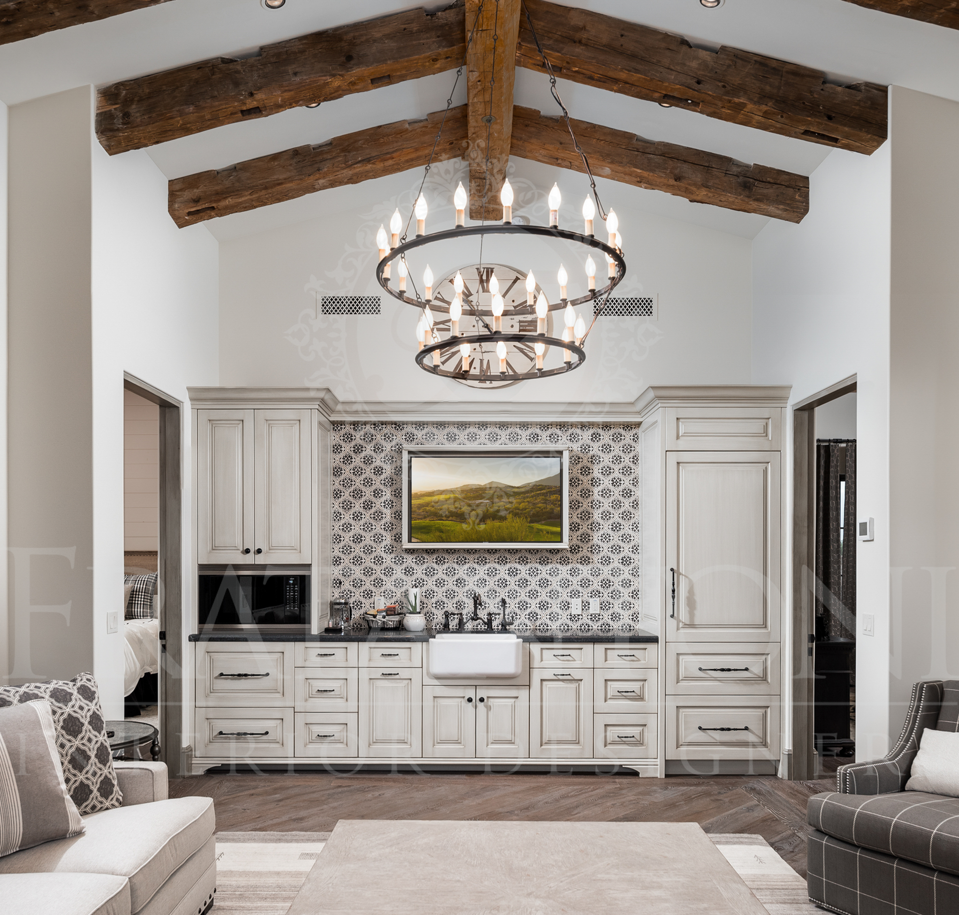Casita great room with vaulted ceiling, exposed beams, chandelier, white cabinets, mosaic backsplash, and a TV.