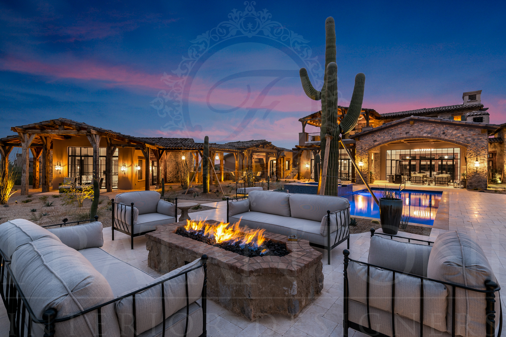 Outdoor patio with fire pit and seating, luxury desert estate, desert landscape at sunset designed by Fratantoni Interior Designers