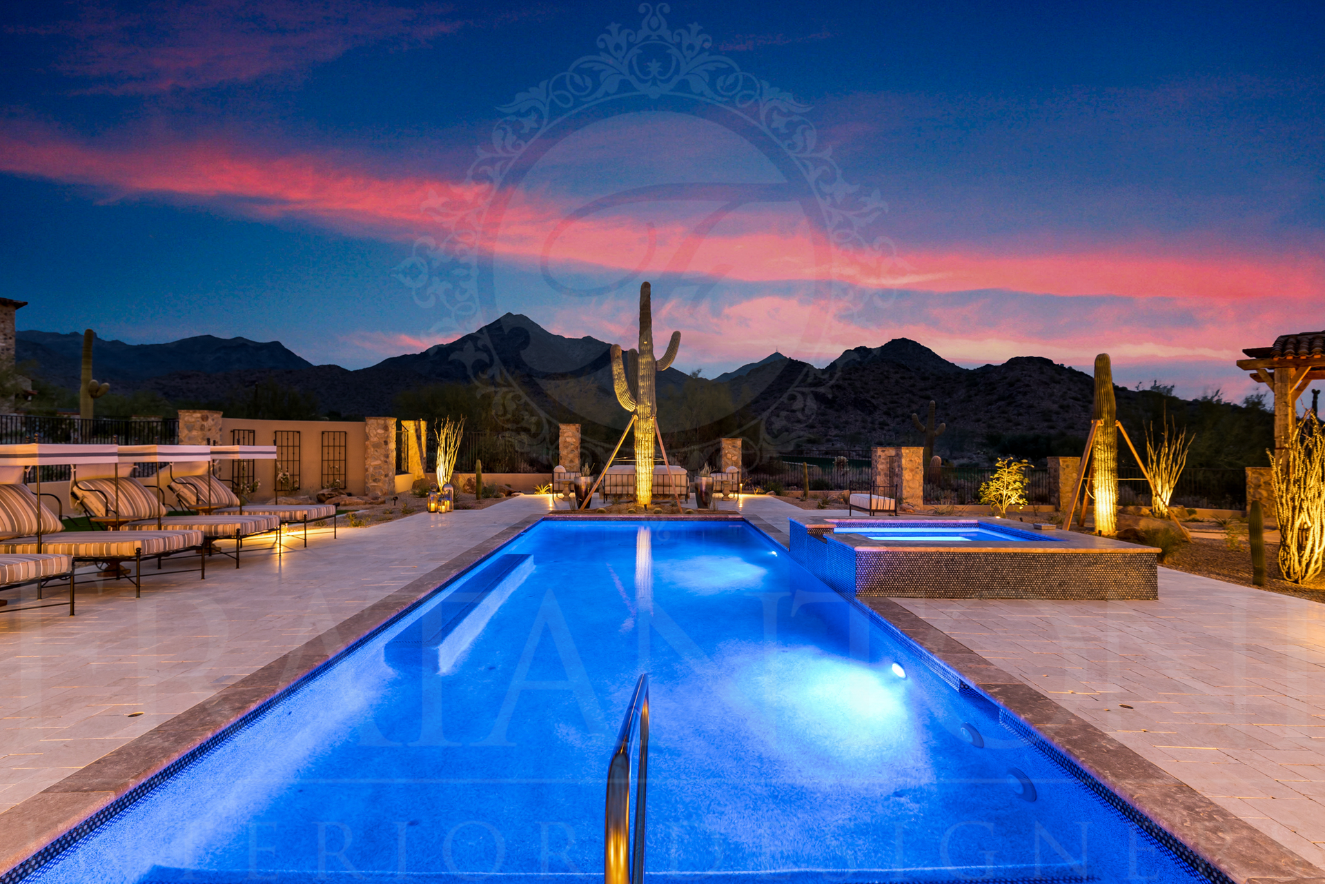 Pool with blue lights, mountains at sunset. Desert landscape, luxury resort feel.