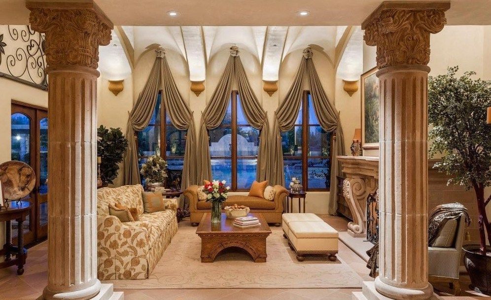 A living room with a lot of furniture and columns