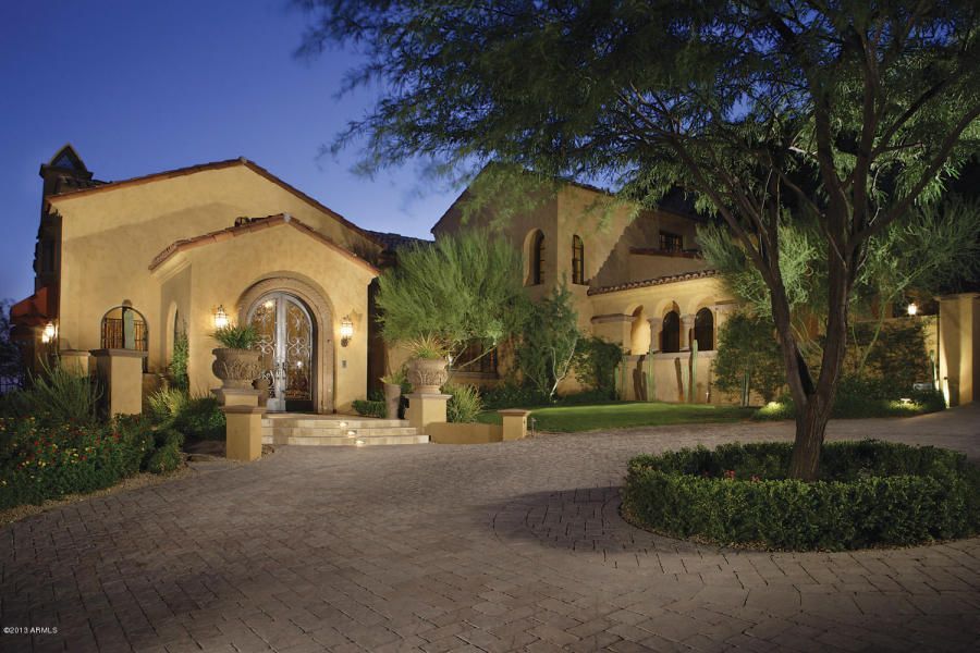 A large house with a tree in front of it