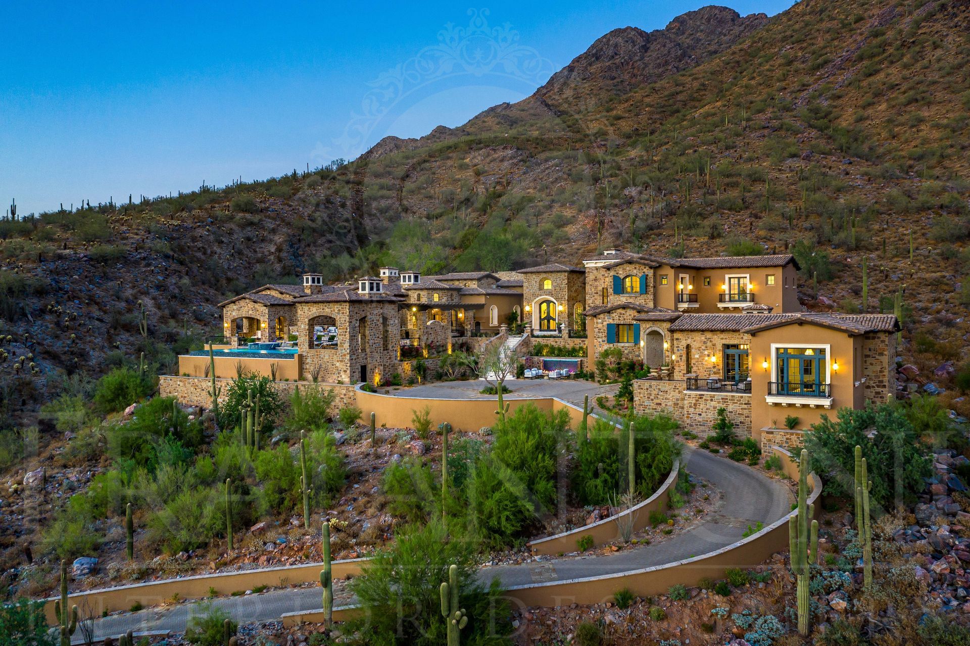French luxury home with long driveway design in desert mountain estate designed by fratantoni interior designers