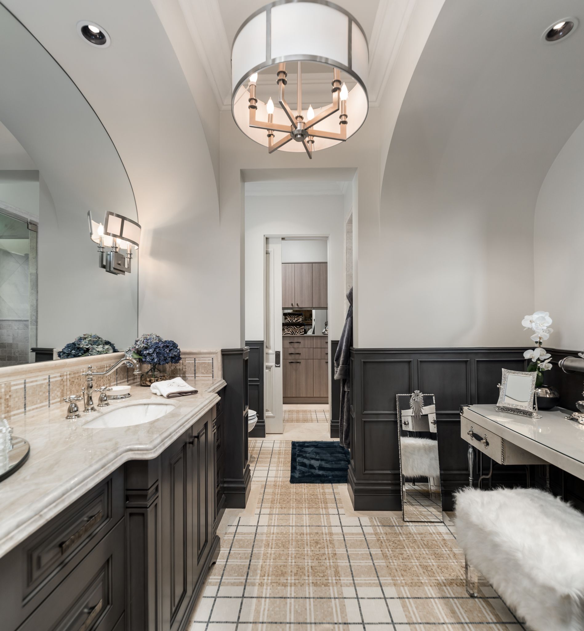 A bathroom with two sinks and a chandelier hanging from the ceiling