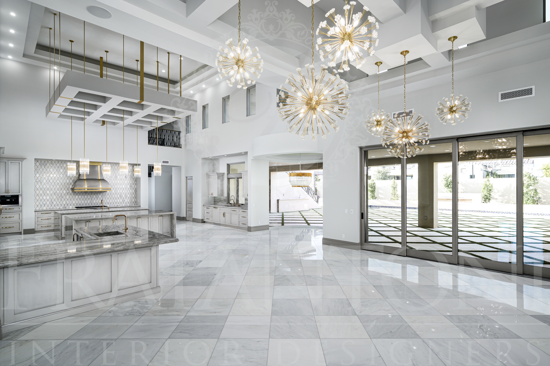 Modern kitchen with marble floors, gold chandeliers, and large glass doors by fratantoni interior designers