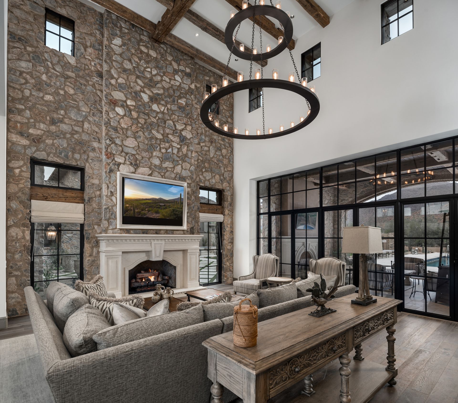 A living room with a stone wall and a fireplace