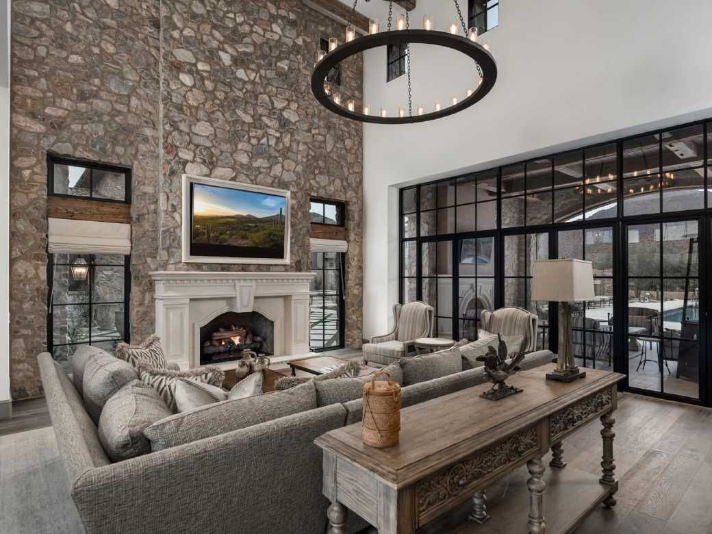 Luxury living room with stone fireplace and chandelier