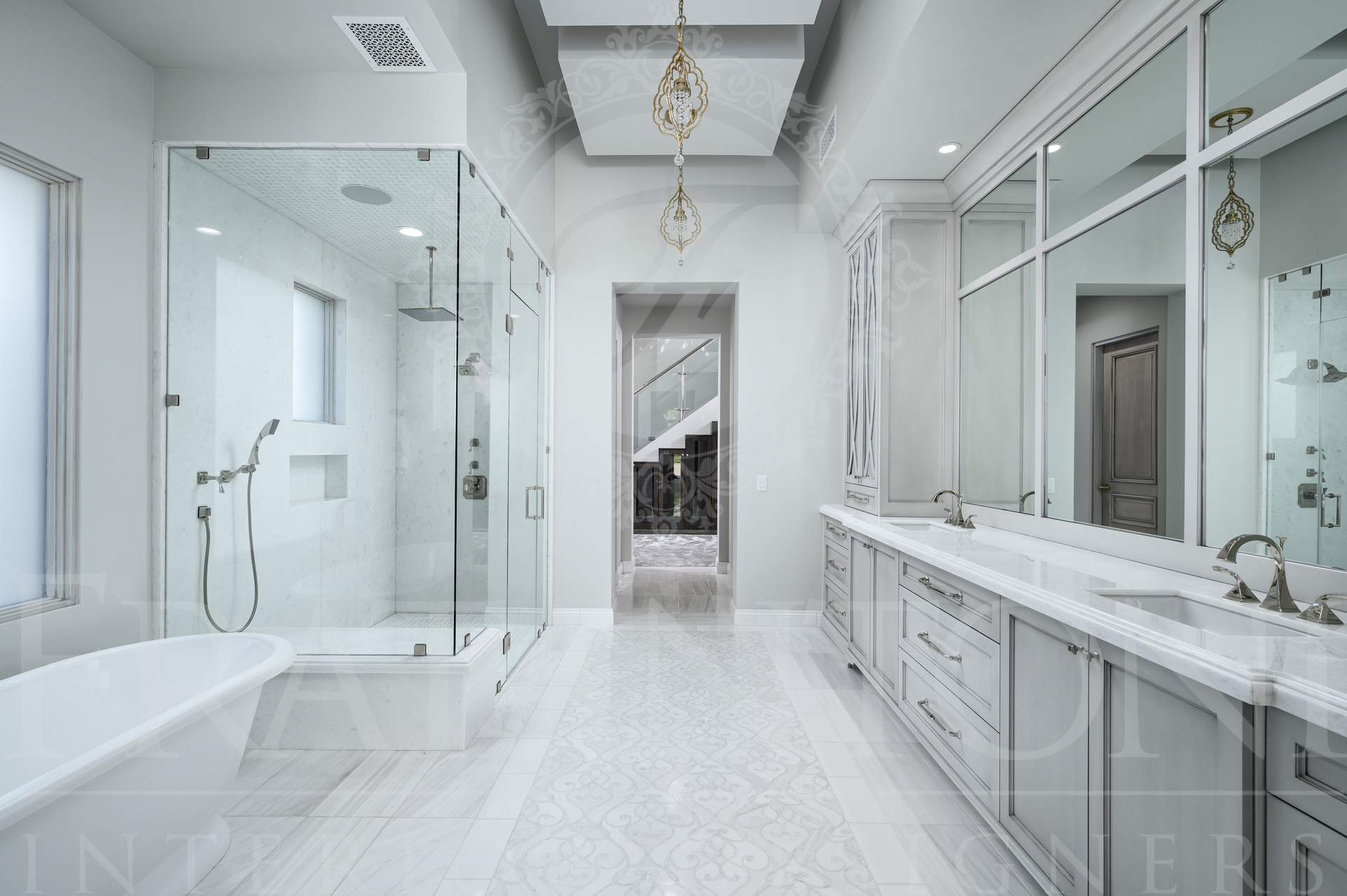 Bright white luxury bathroom with glass shower, double vanity, detailed marble floors, freestanding tub, and large mirror. Designed by Fratantoni Interior Designers in Scottsdale, Arizona
