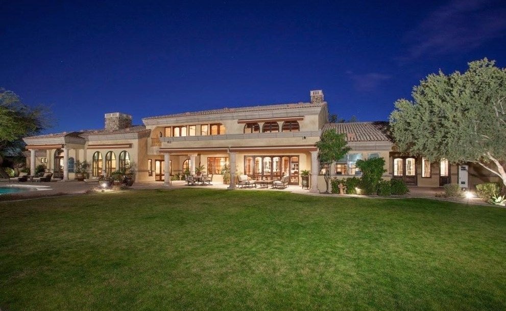 A large house with a large lawn in front of it