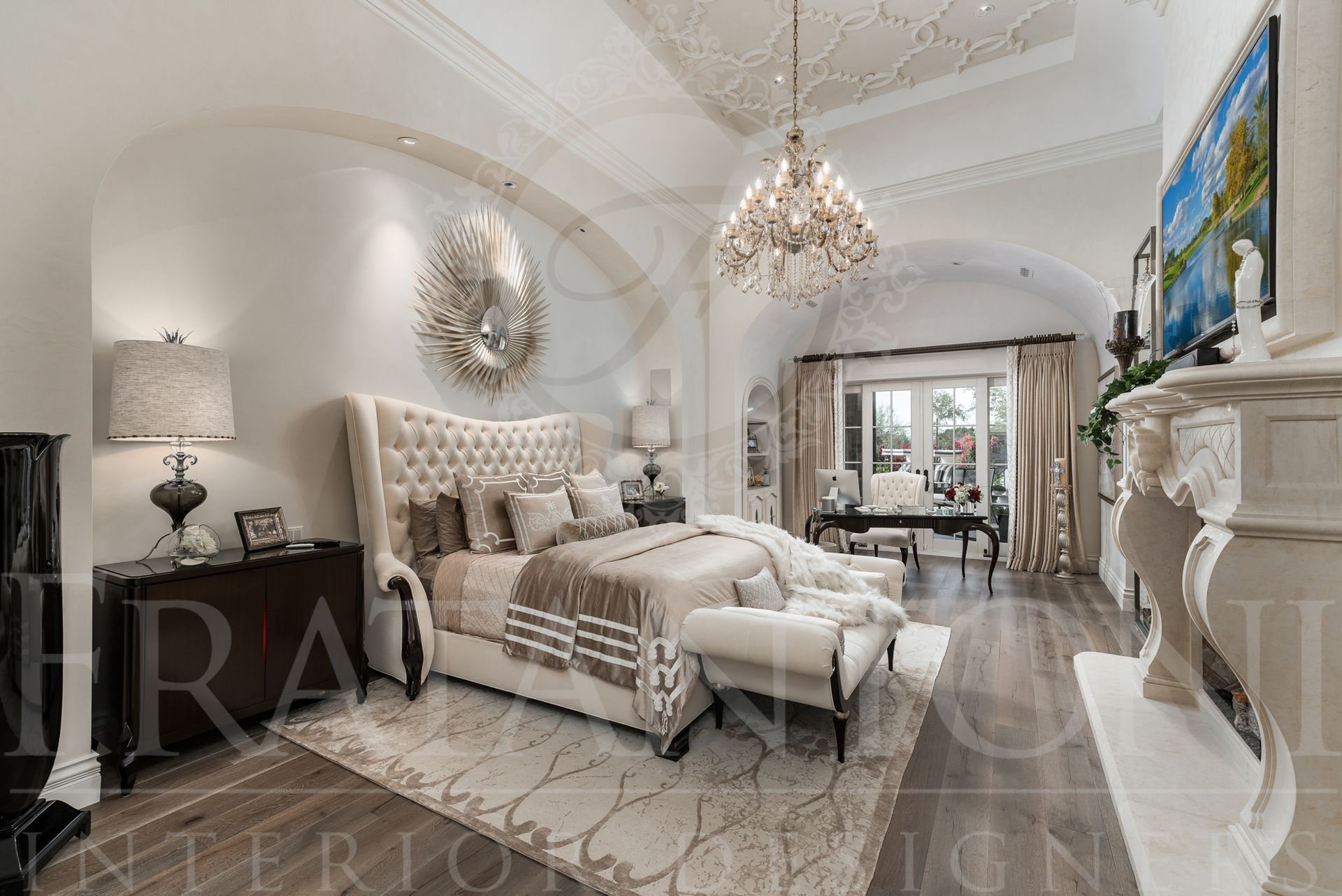 Luxurious master bedroom with ornate ceiling, chandelier, tall upholstered bed, and carved stone fireplace designed by fratantoni interior designers in scottsdale, arizona