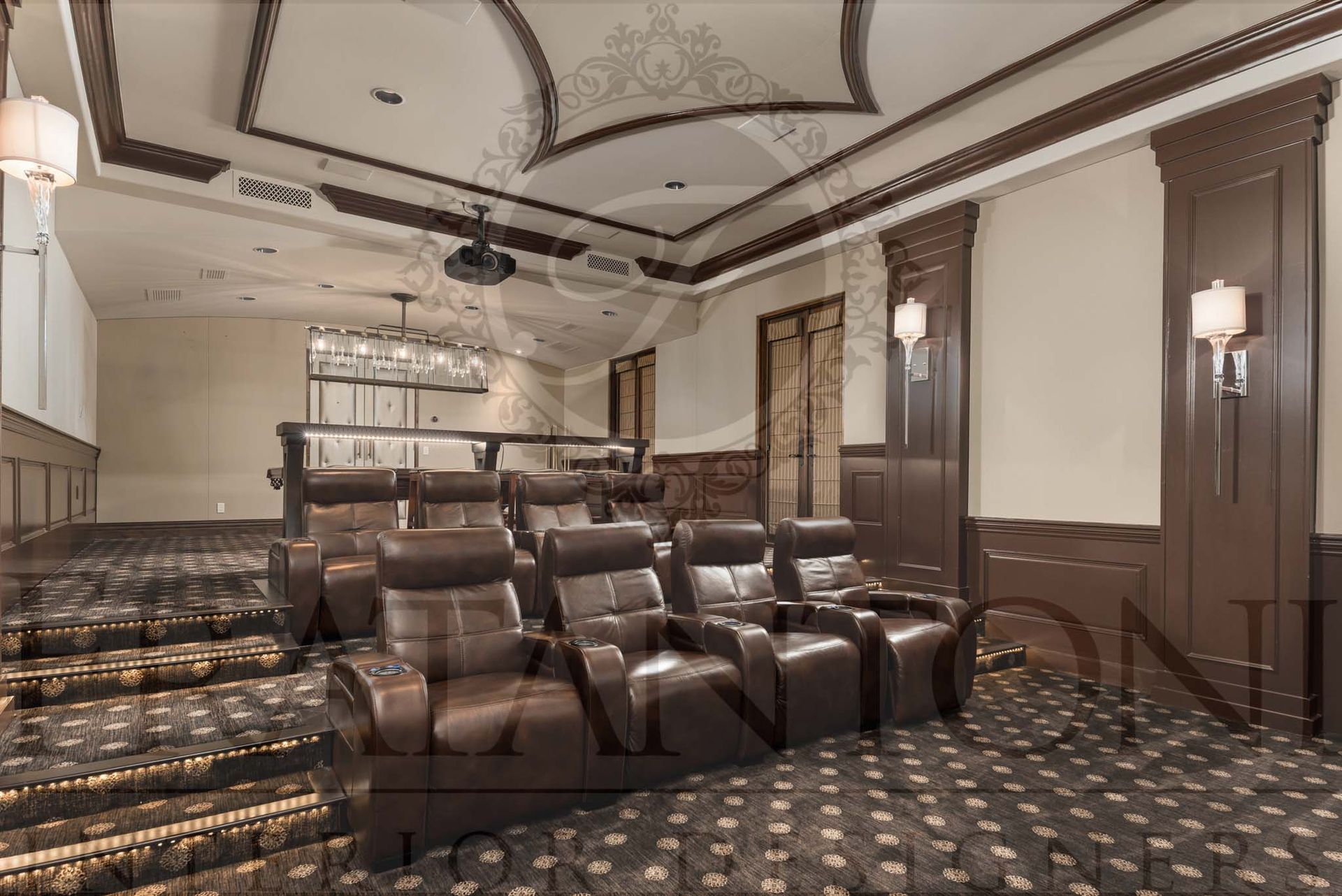 Elegant home theater with rows of leather recliners, patterned carpet, and a decorative ceiling designed by Fratantoni Interior Designers