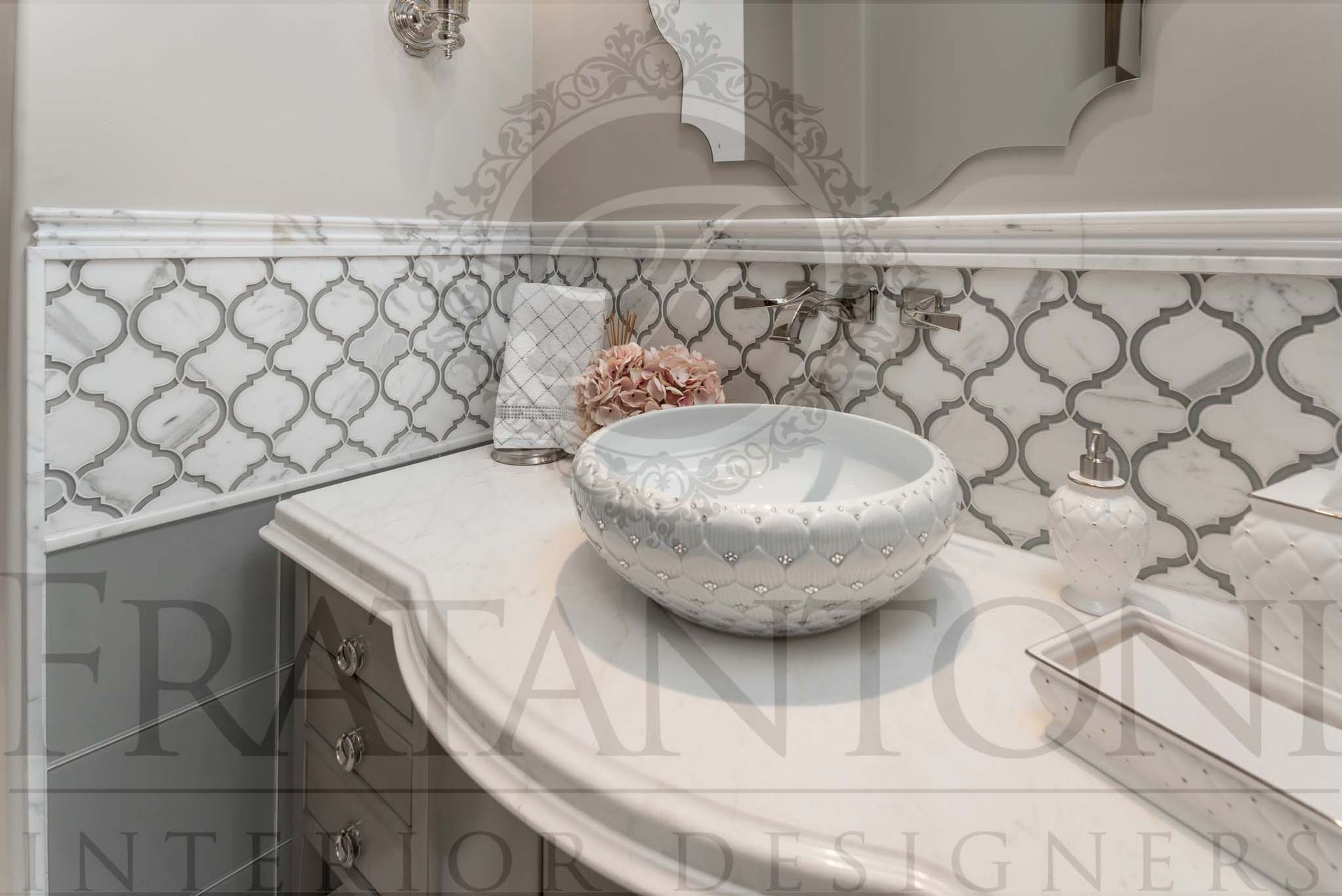 Decorative bathroom vanity with white marble countertop, round vessel sink, and gray quatrefoil tile backsplash designed by luxury interior designers in arizona