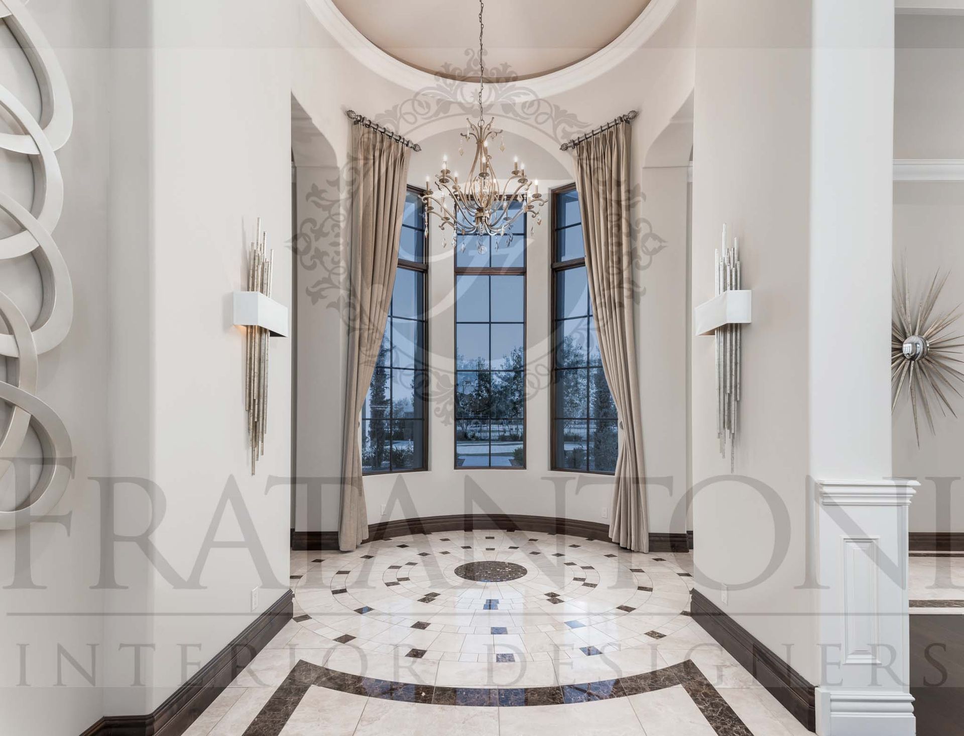 Grand marble foyer with tall windows, chandelier, and patterned floor in a bright luxury home designed by Fratantoni Interior Designers in scottsdale arizona