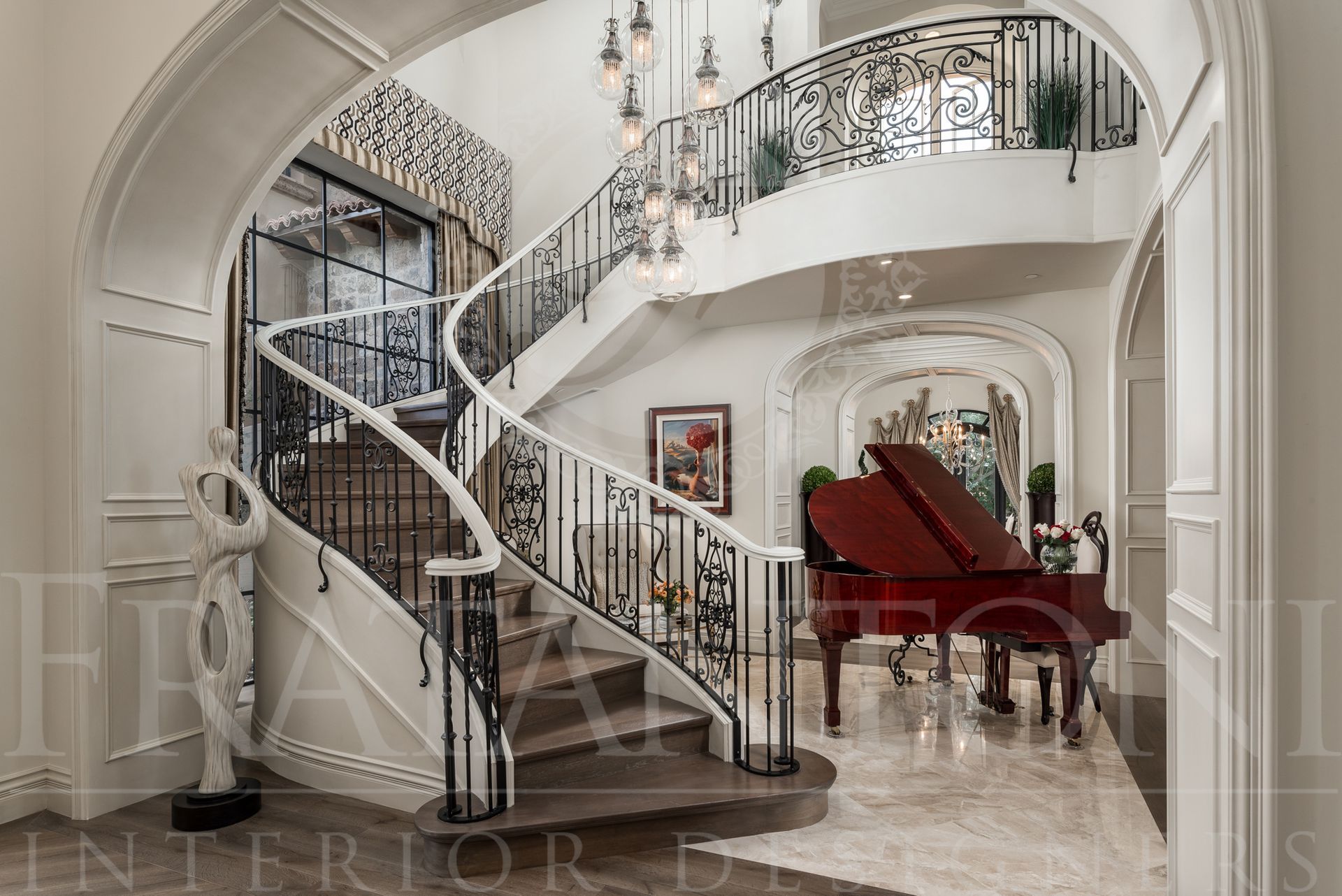 Elegant foyer with curved staircase, grand piano, and sculpture. White and black accents. Designed by fratantoni interior designers in scottsdale, arizona