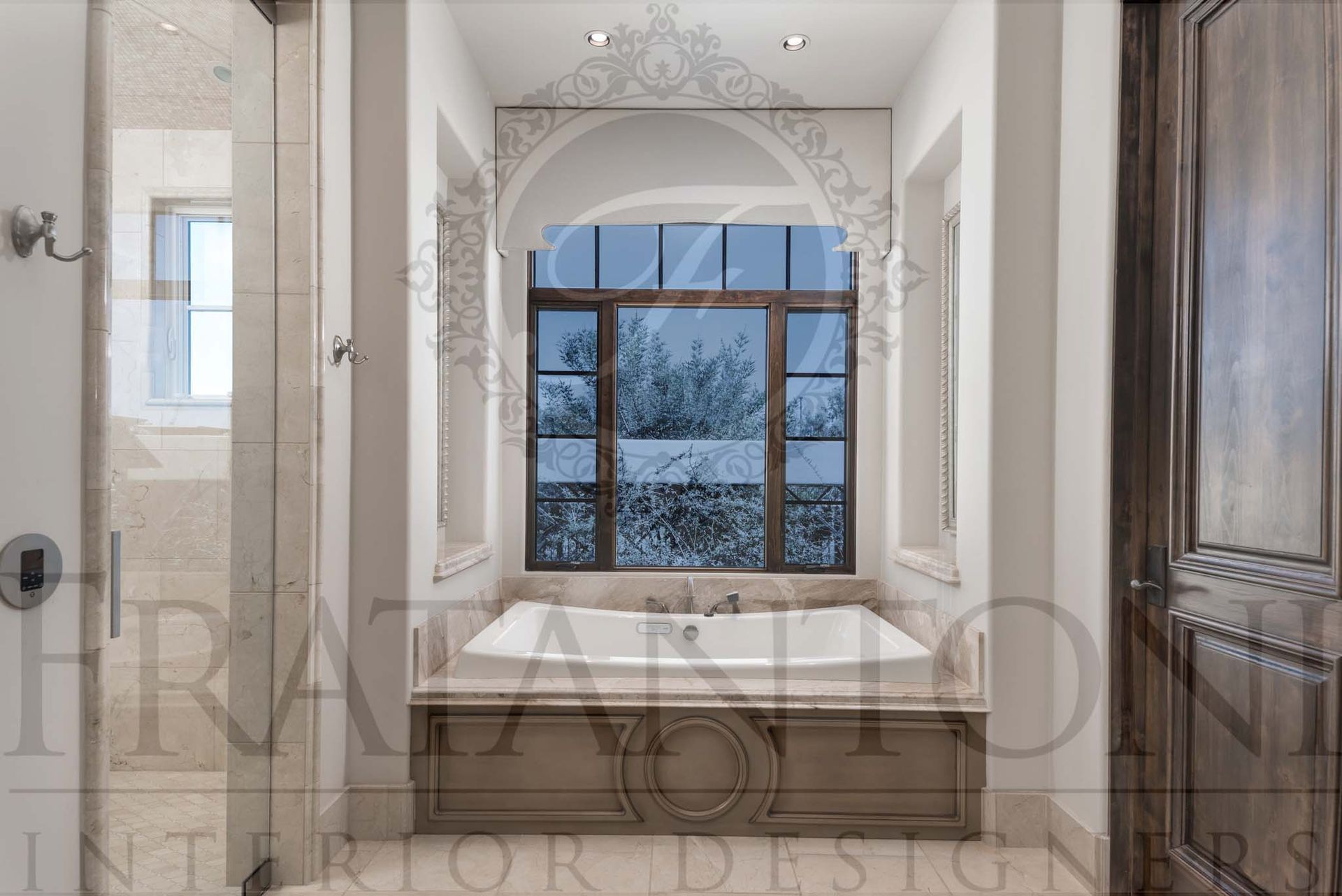 Elegant bathroom with a white bathtub beneath a large window and marble tile floors.