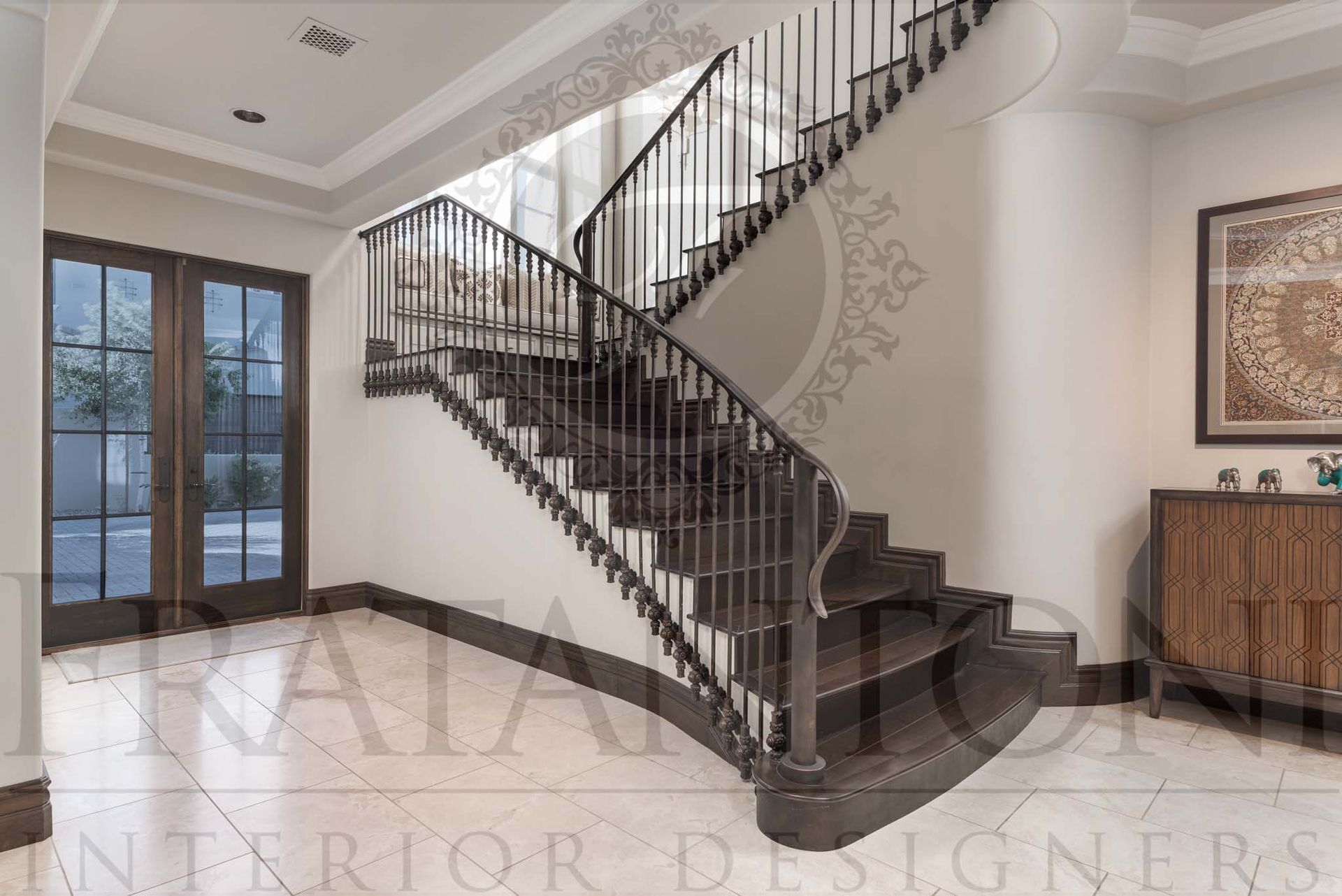 Elegant foyer with a curved dark wood staircase, marble tiled floor, and glass double doors designed by Fratantoni Interior Designers in scottsdale, arizona
