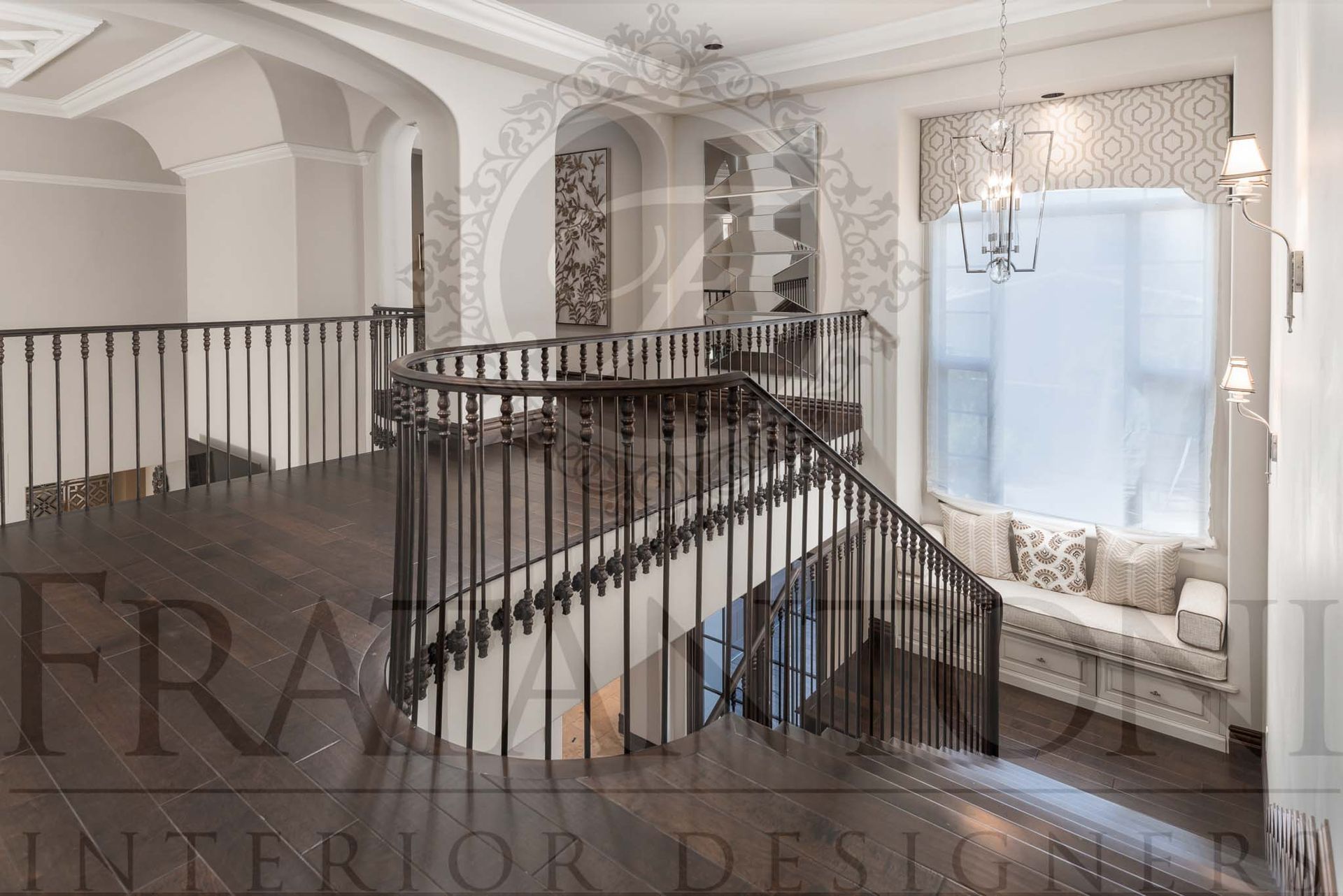 Elegant staircase landing with black railings, dark wood floors, arched openings, and a bright windowed alcove with a window seat designed by fratantoni interior designers