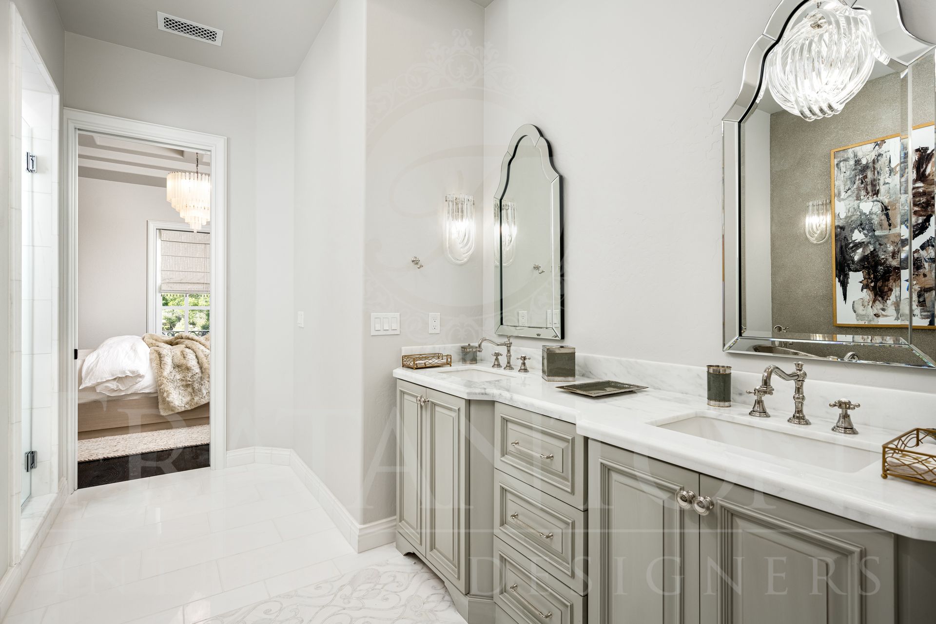 Elegant jack and Jill bathroom with double vanity, ornate mirrors, and a glimpse into a bedroom. White and gray tones. Designed by Fratantoni Interior Designers in Scottsdale, arizona