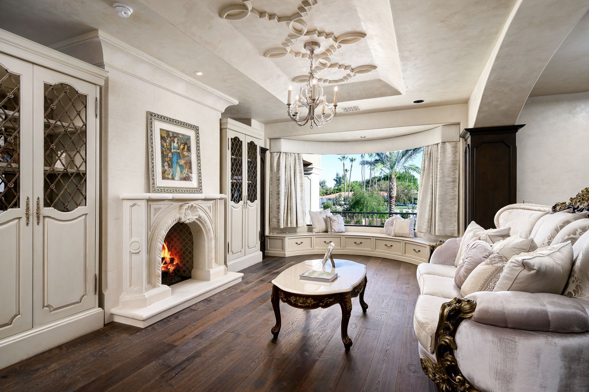 Luxury living room with fireplace and large windows.