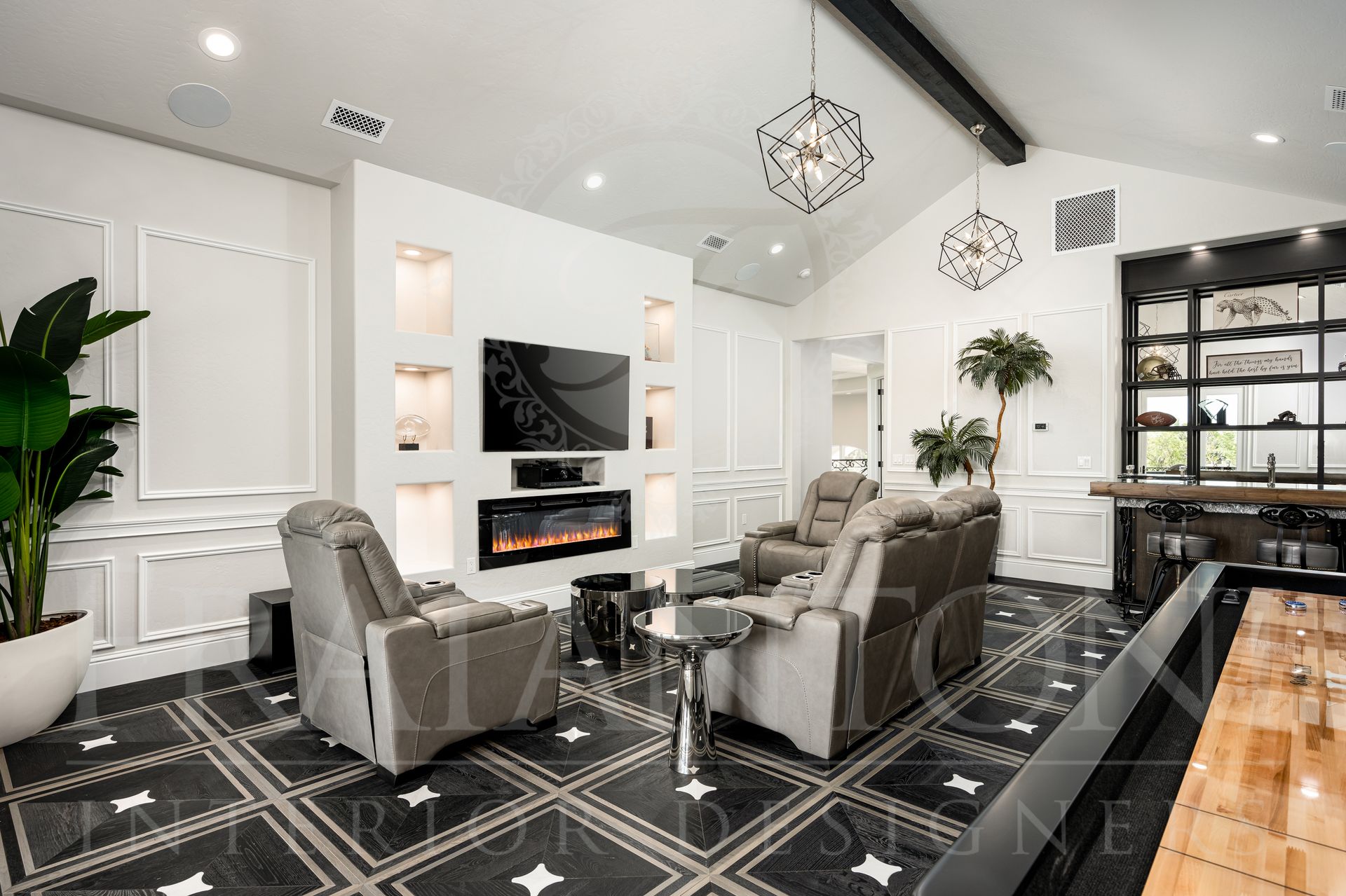Luxurious movie room with black and white tile floor, modern fireplace, and recliner seating. Also seen is a game table and a home bar.