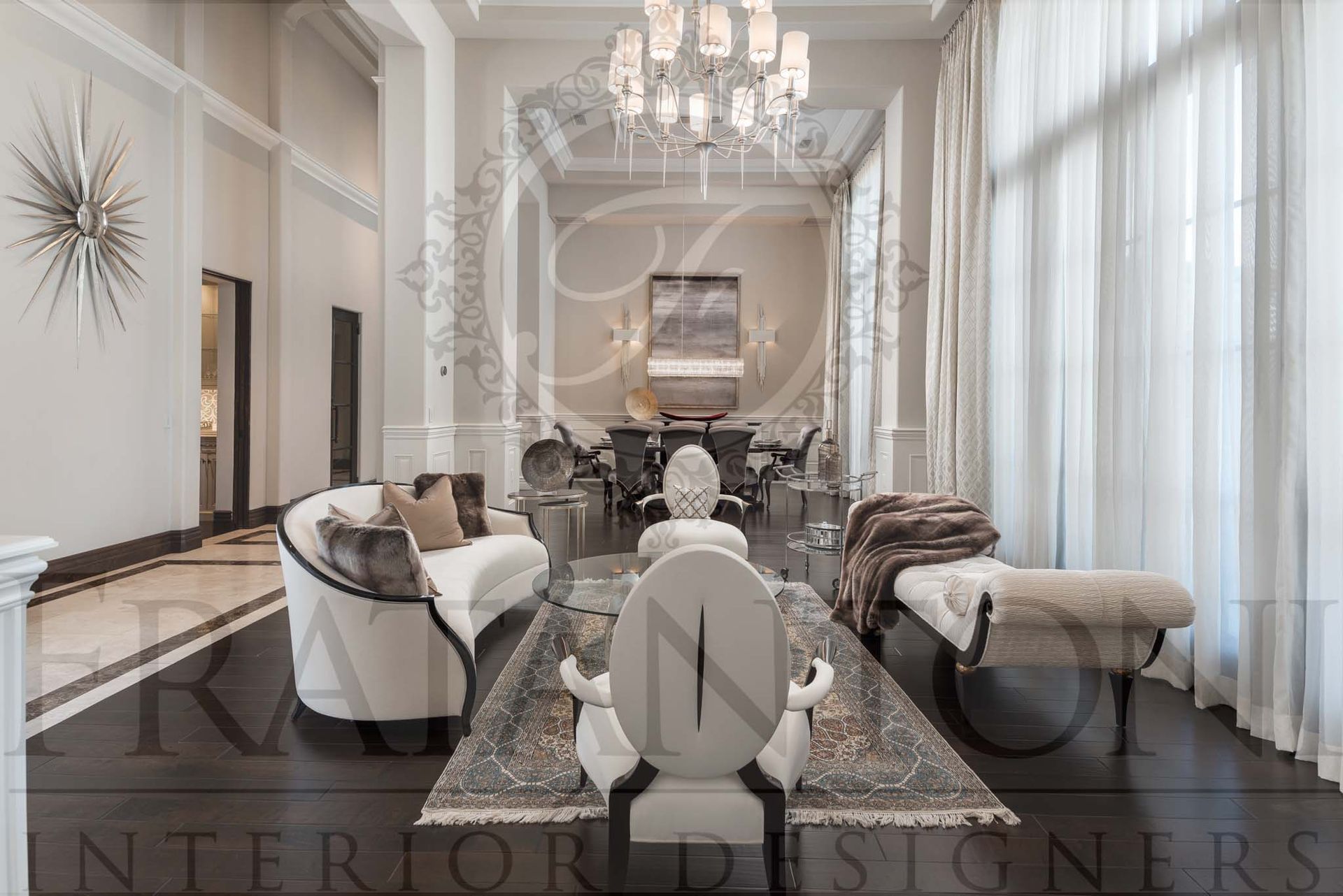Elegant bright living room with chandelier, and two-story floor to ceiling windows letting in soft daylight through sheer curtains designed by Fratantoni Interior Designers in arizona
