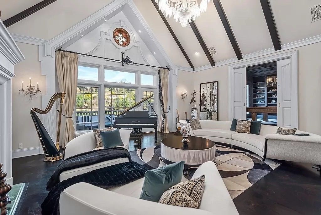 A living room with a piano and a harp in it