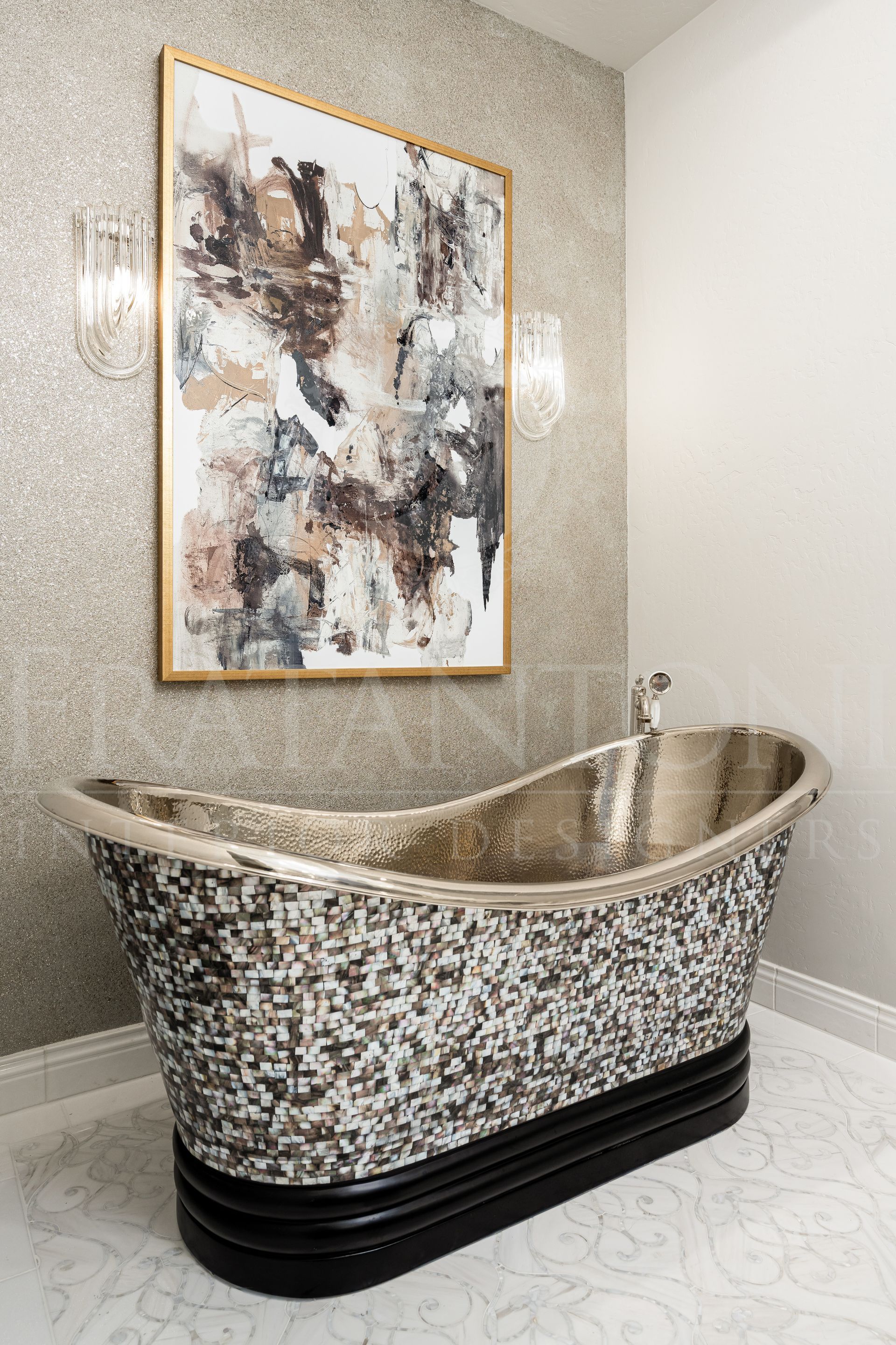 Luxury bathroom with mosaic-tiled bathtub, gold accents, and abstract art on a sparkling wall designed by Fratantoni Interior Designers
