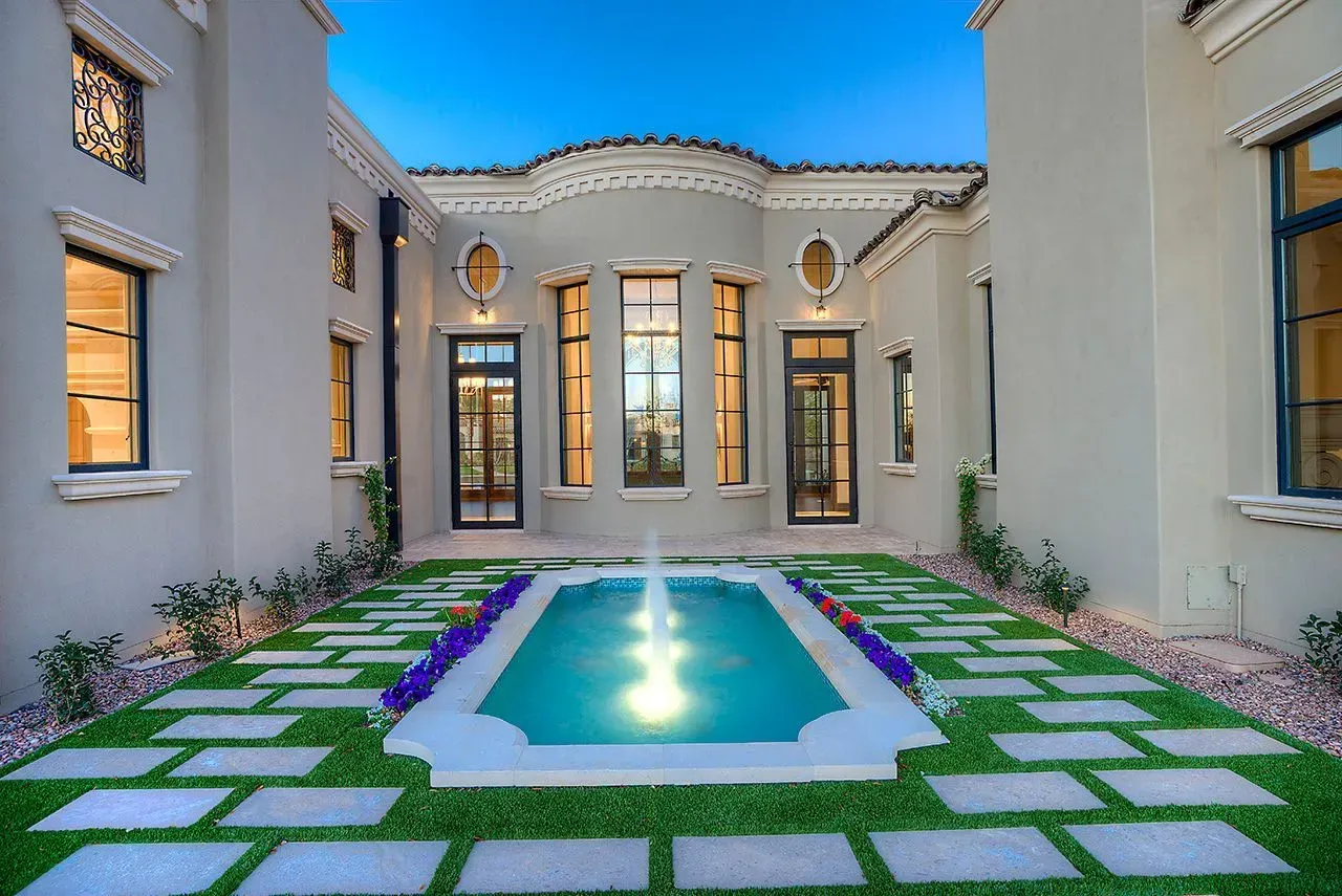 Custom courtyard design with fountain in Bolero home with transitional exterior design.