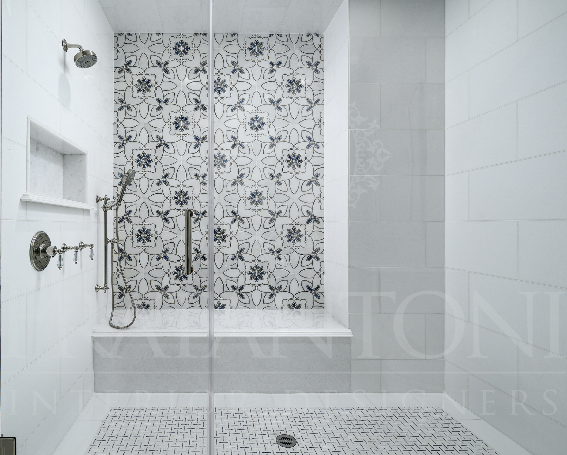 Luxury custom walk-in shower with mosaic tile wall and marble tiles with stainless steel fixtures designed by fratantoni interior designers