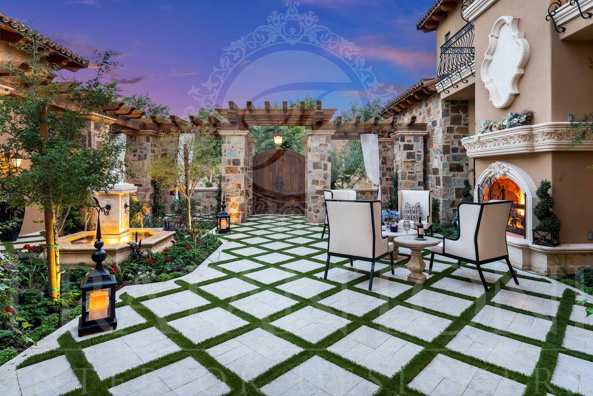 Outdoor patio with stone pathway and green grass, fountain, and arched pergola under a dusk sky.