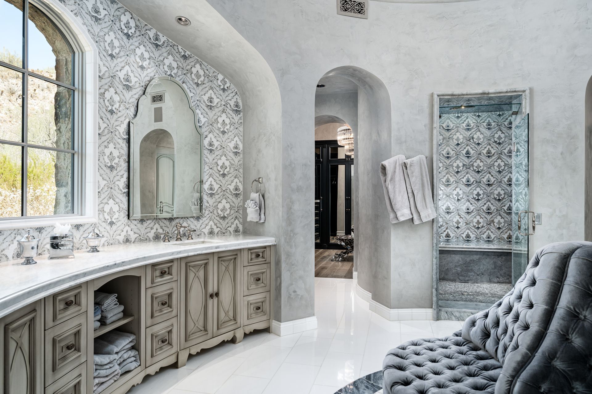 Luxury bathroom with custom vanity and patterned tile shower