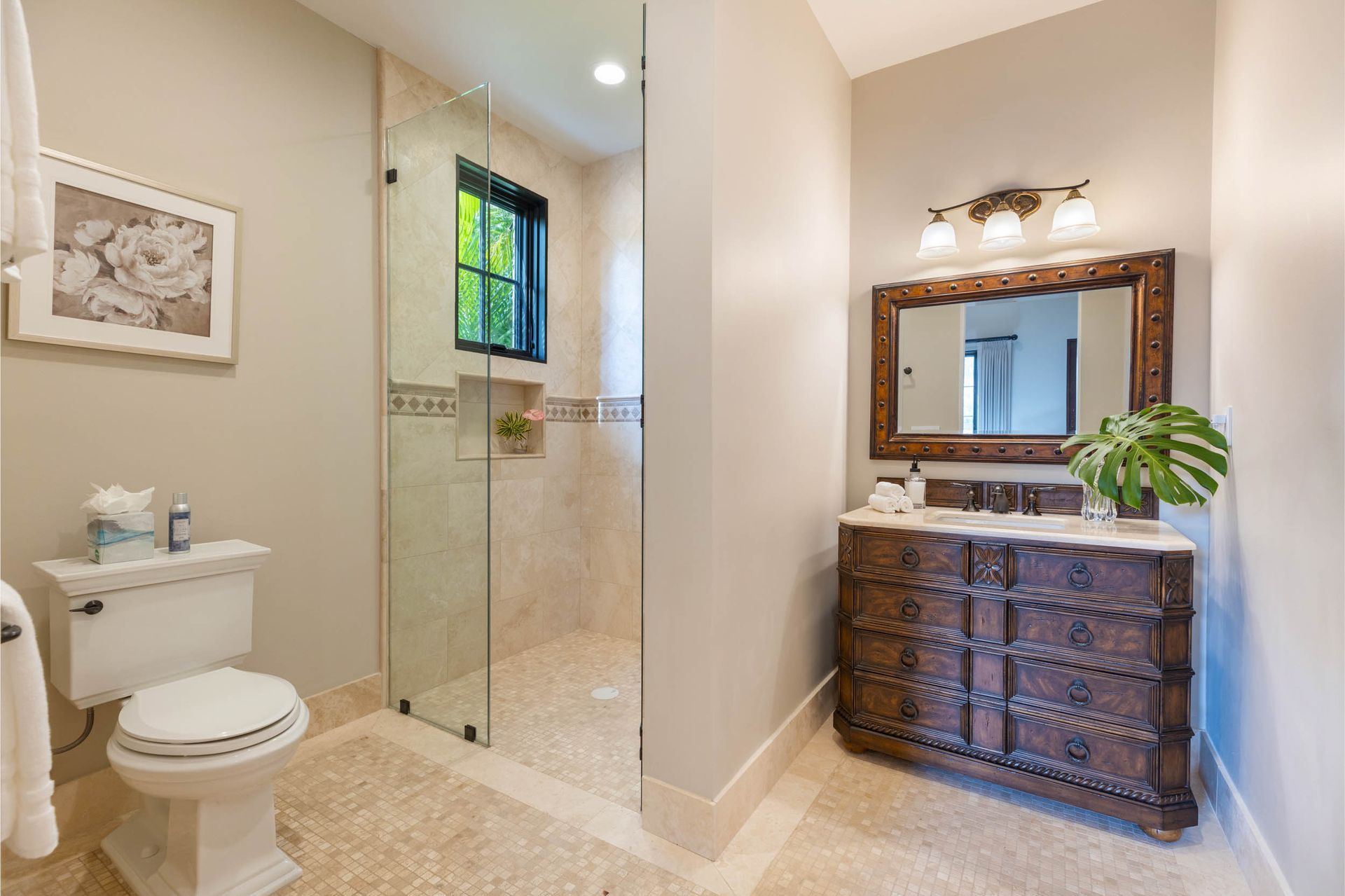 Bathroom with a toilet, shower, vanity, and large mirror. Light tan walls and beige tile floor.