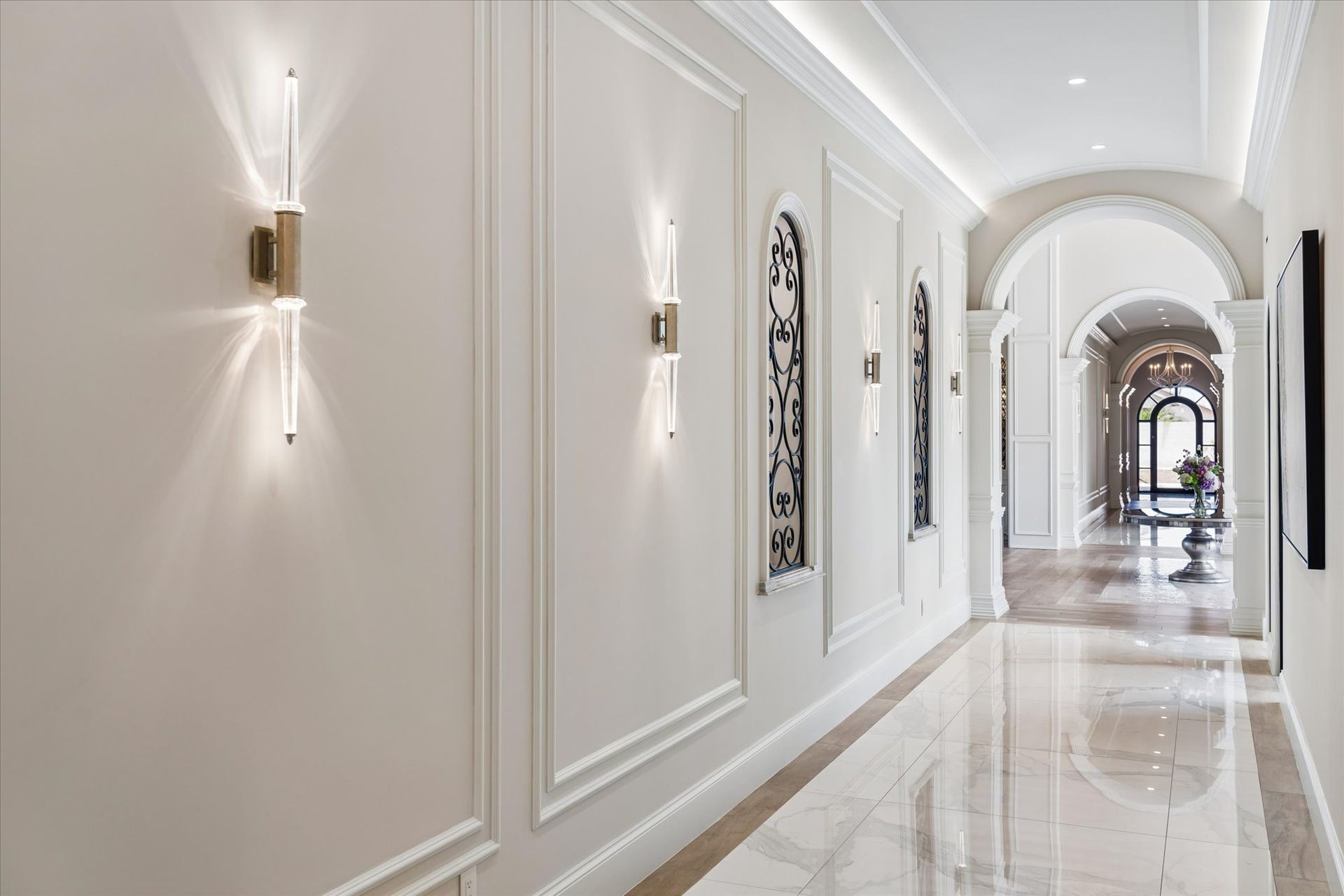 Luxury home hallway with arched ceiling, and wall sconces by Fratantoni Interior Designers