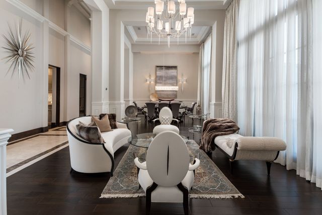 Custom luxury living room design with transitional style couch and seating, open concept layout.