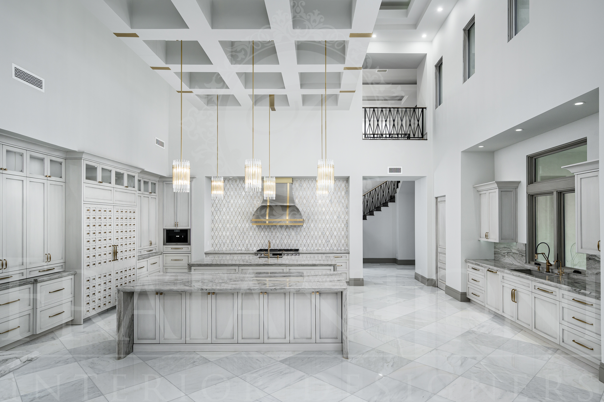 Luxury kitchen with marble island, pendant lights, and mirrored cabinets in Scottsdale, Arizona