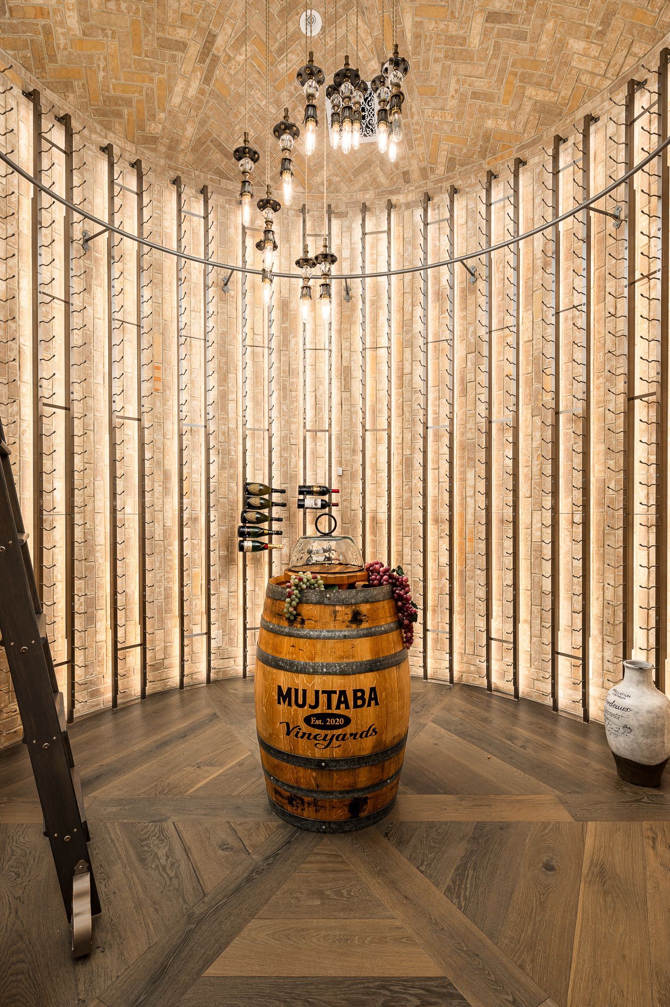 Custom wine cellar interior design with a wooden barrel and metal railing in a rustic room