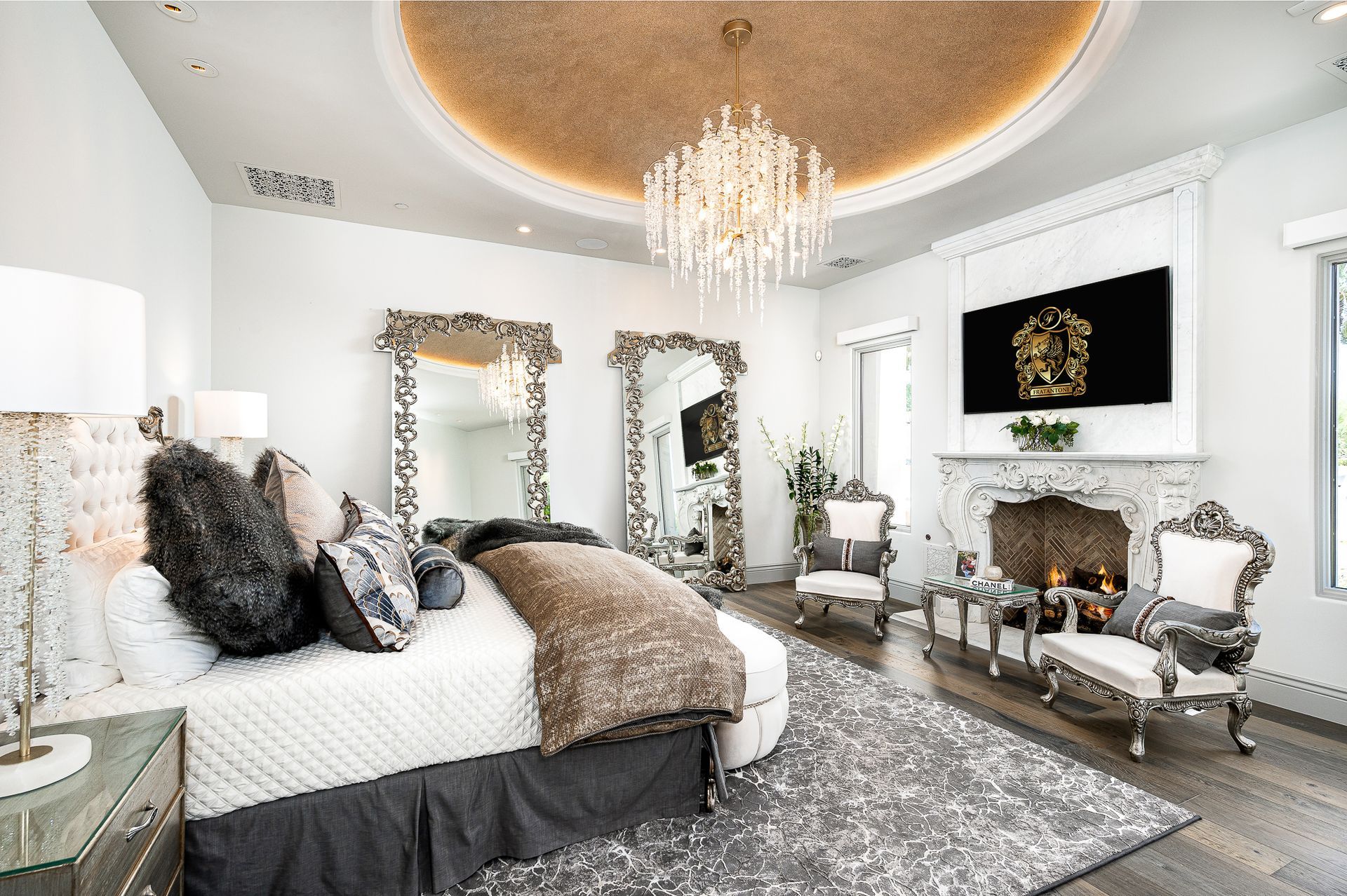 primary suite with luxury furniture and chandelier