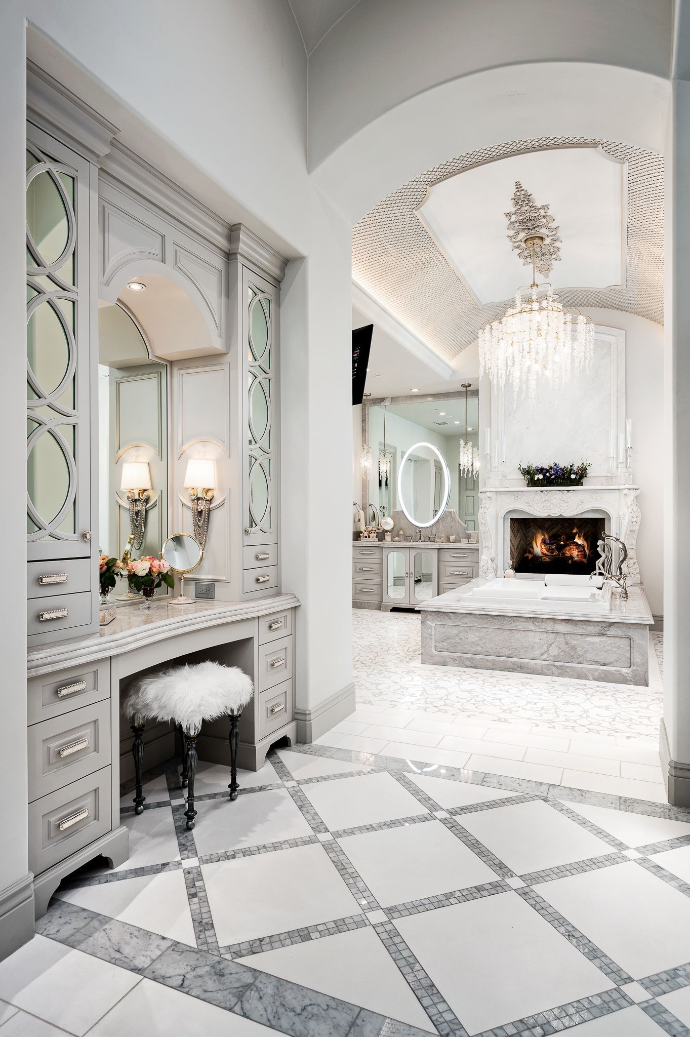 Elegant white bathroom with vanity, fireplace, and ornate ceiling.