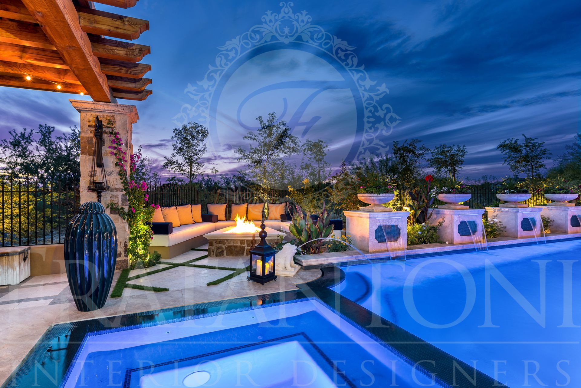 Nighttime outdoor patio with pool, hot tub, fire pit, exterior lighting, and seating under a pergola.