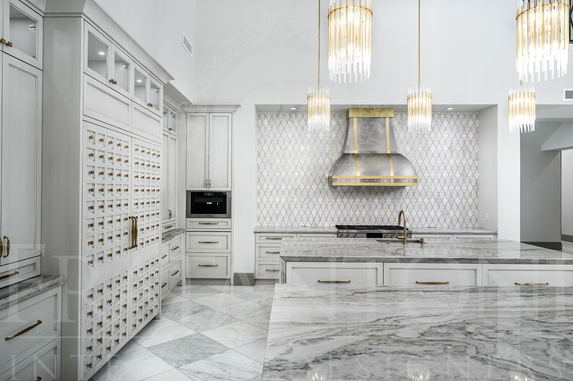 Elegant custom kitchen with marble floors, mosaic backsplash, stainless custom range hood, and pendant lights in scottsdale, arizona.