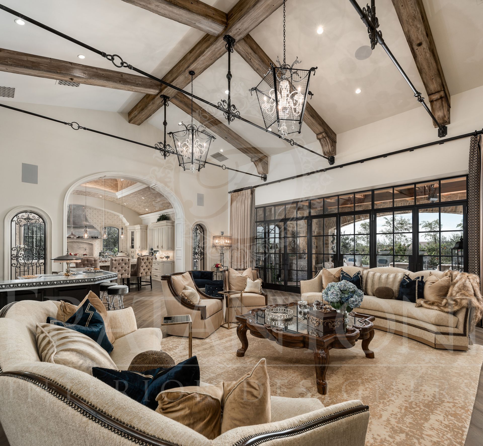 Elegant neutral living room with high ceilings, exposed beams, a wall of glass doors, a courtyard view and ornate furniture designed by Fratantoni Interior Designers in scottsdale, arizona.