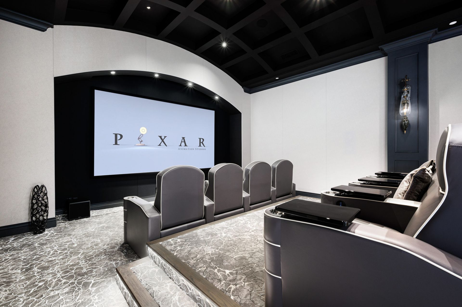A home theater with a pixar logo on the screen