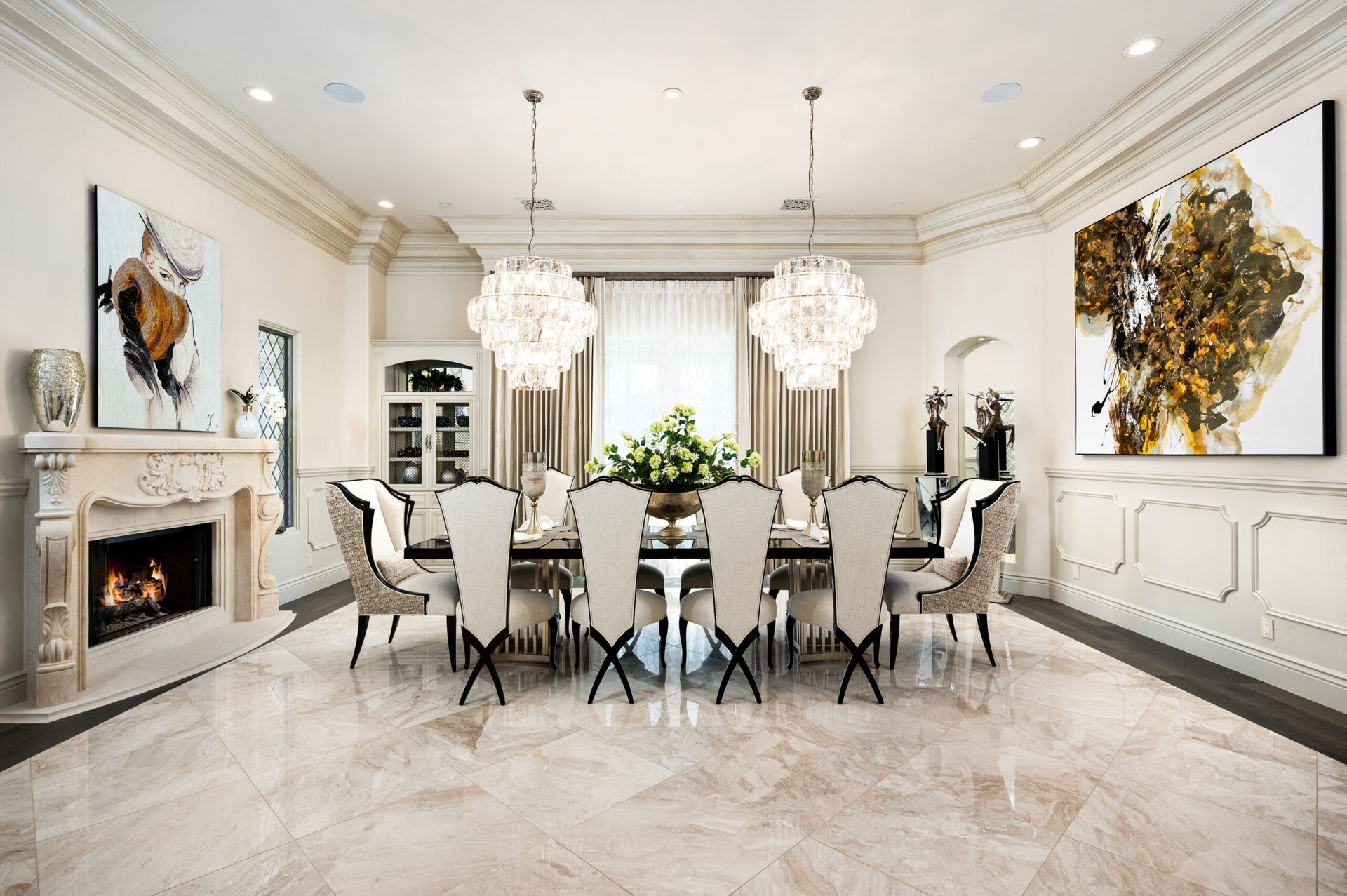 A large dining room with a table and chairs and a fireplace.